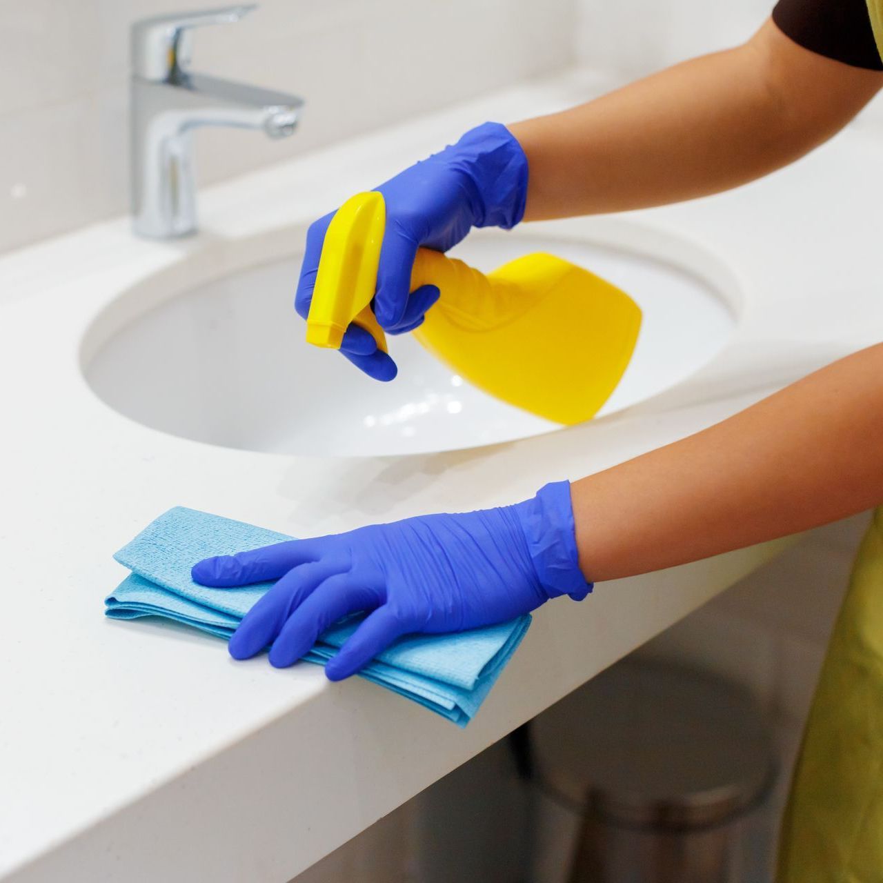 woman cleaning the bathroom sink