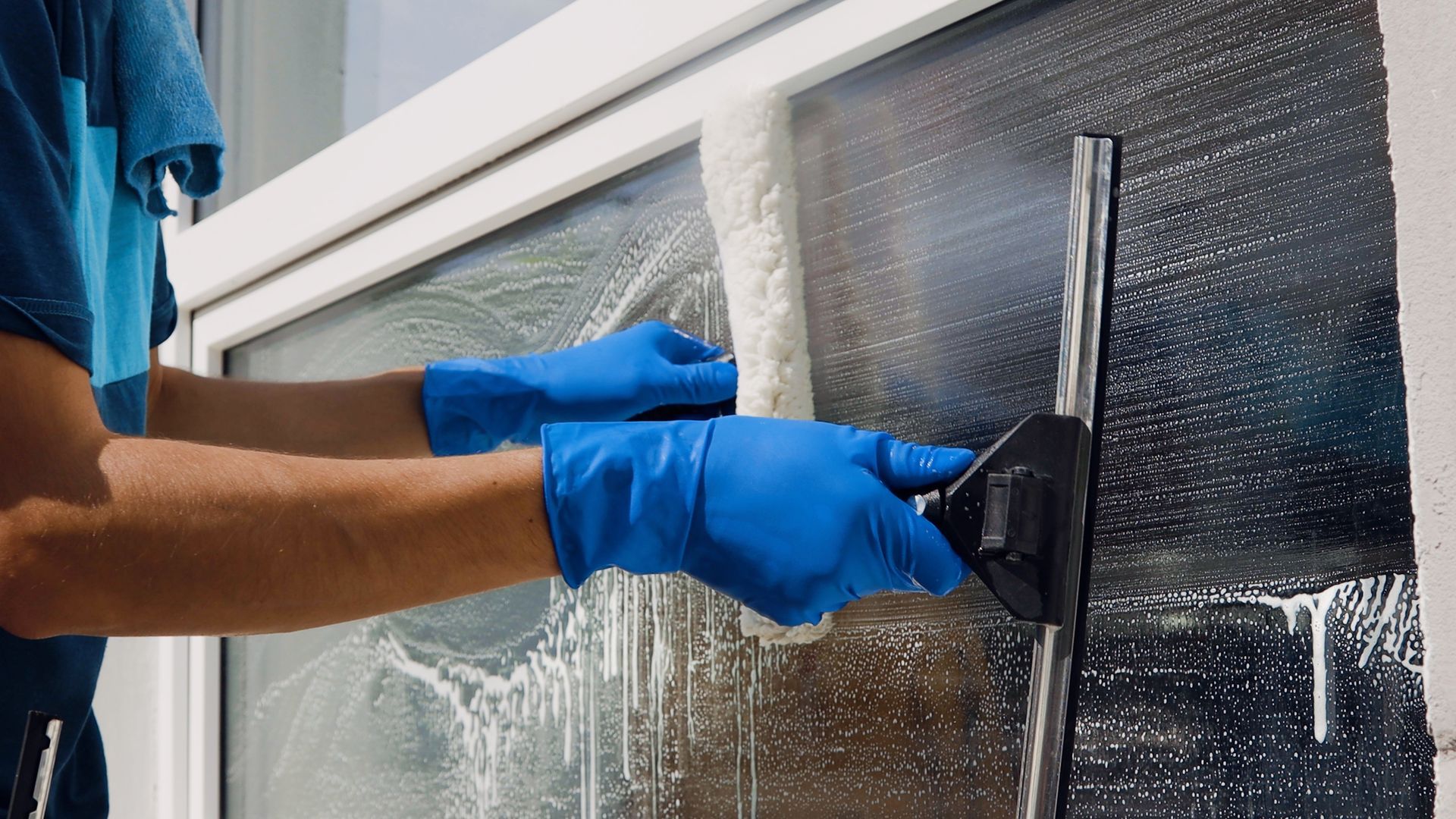 man cleaning a window