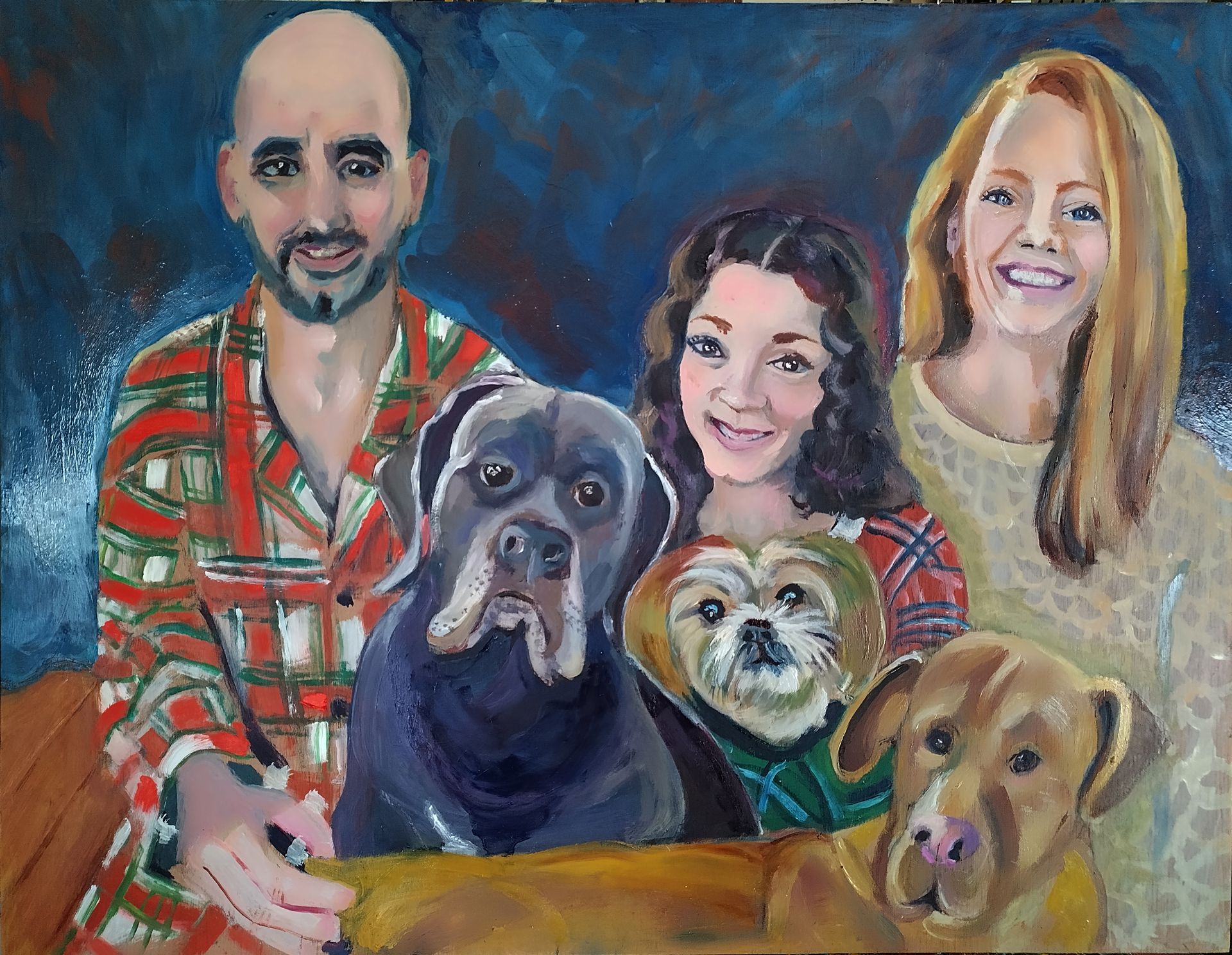 Family portrait with two adults, two children, and three dogs on a painted background