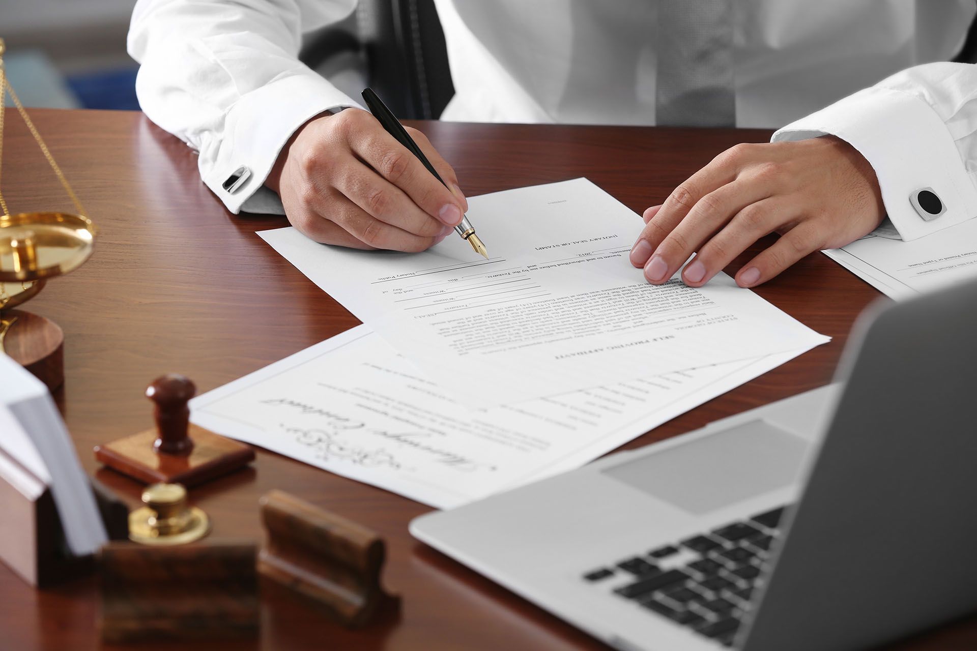 Notary public in office signing document.