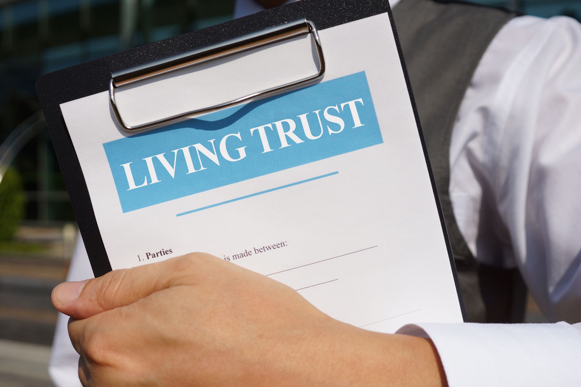 Attorney holding a living trust form.