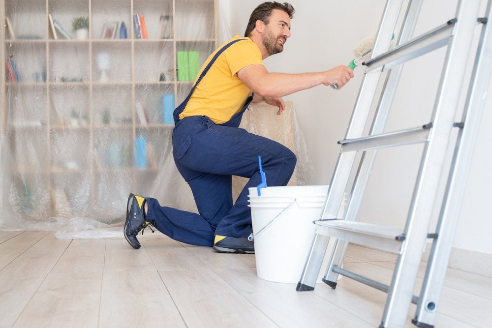 Painter Working at Home with Painting Tools — Massillon, OH — Kamph’s Hardware and Plumbing Services