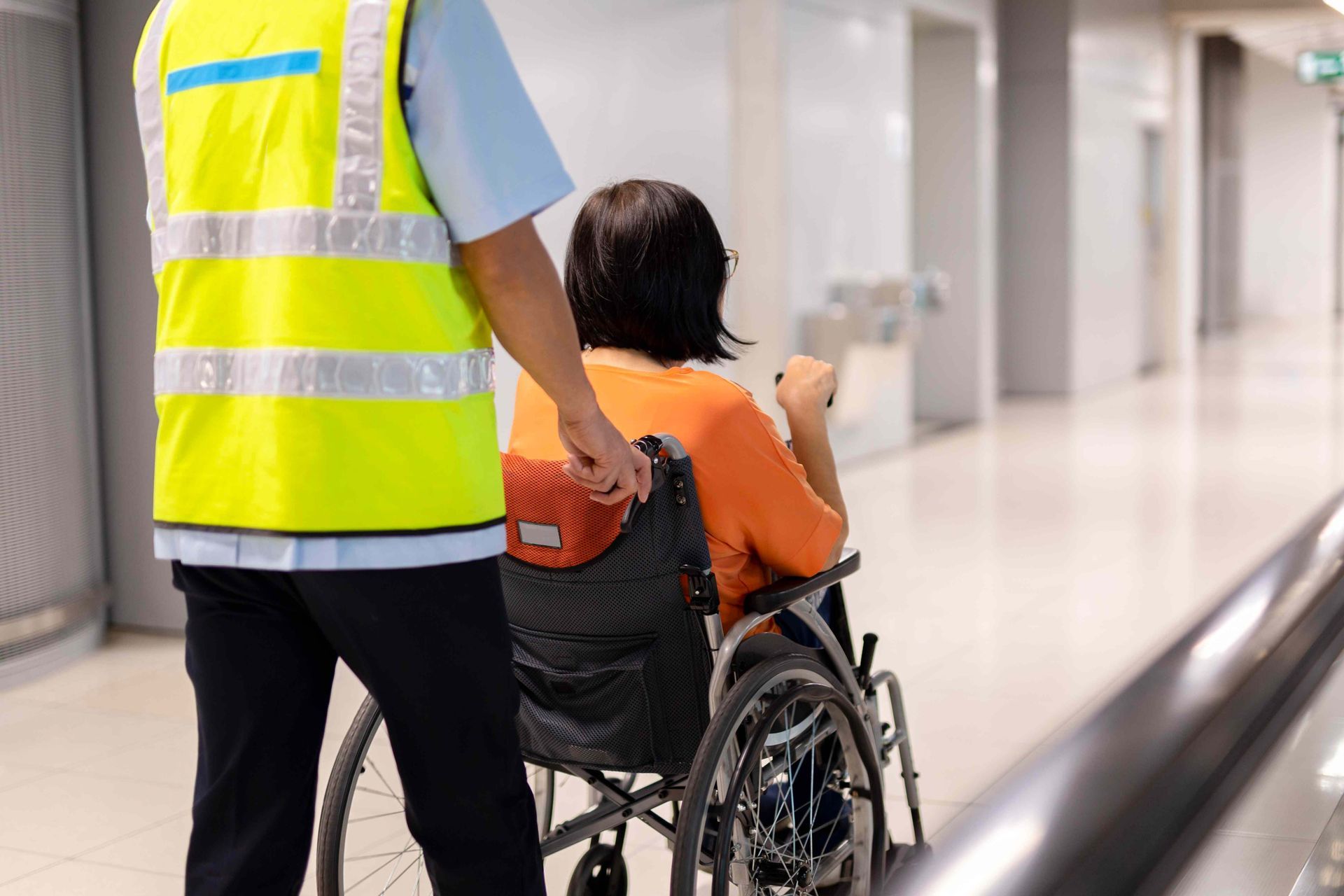 Texas Senior Care Transpor_Caregiver pulling a wheelchair with a passenger