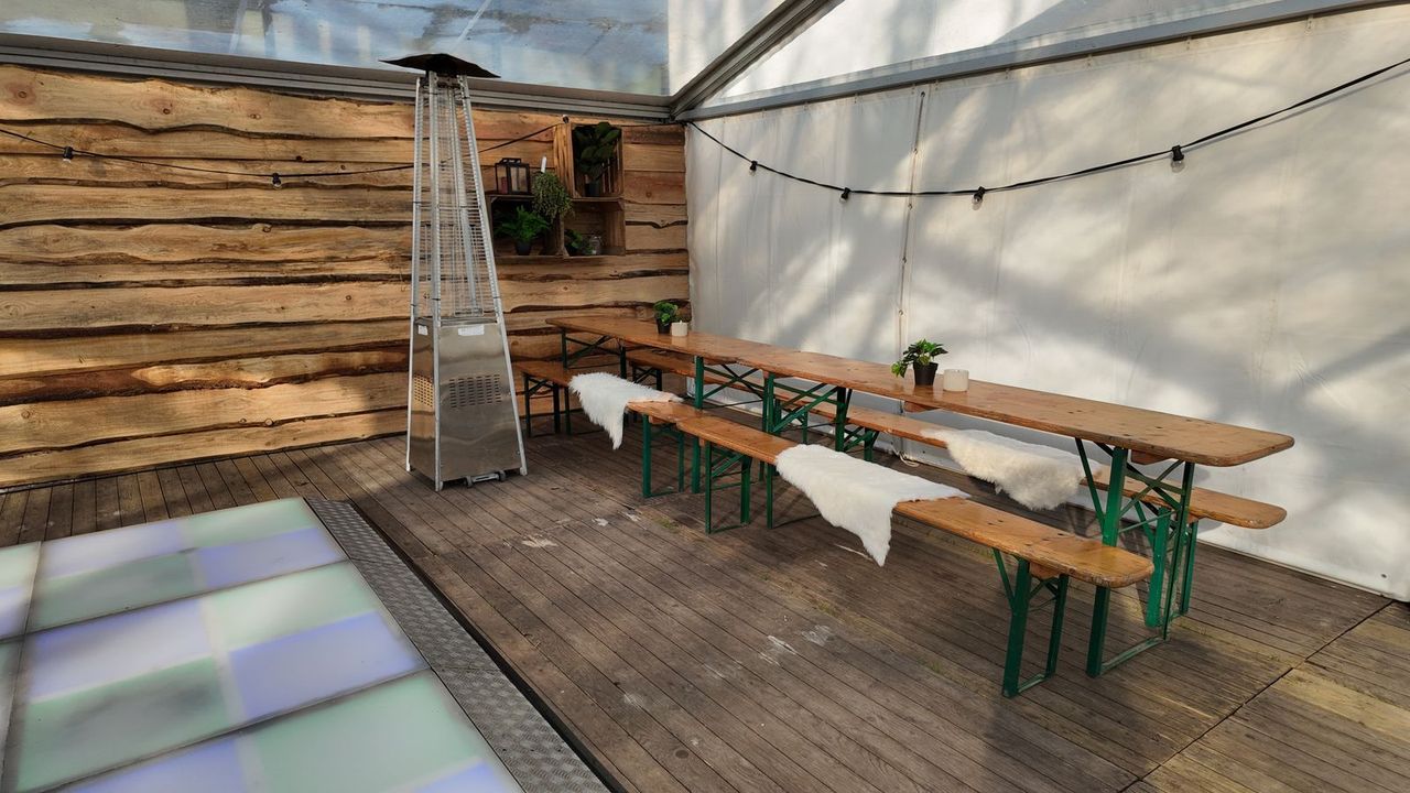 Bierbanken met vachten langs de houten wand