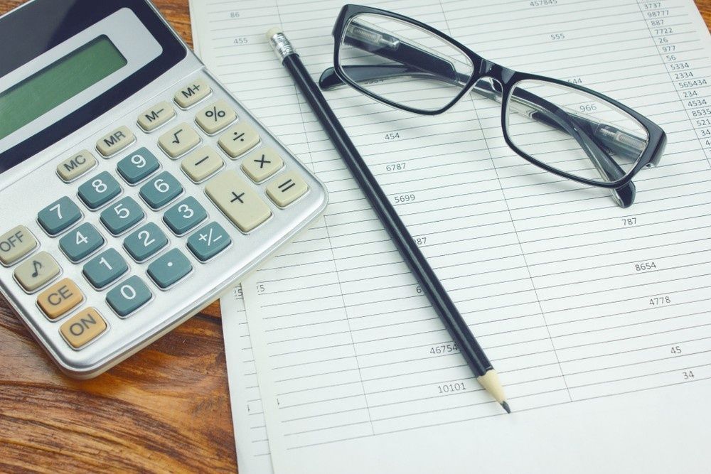 Calculator, Pencil, and Eyeglasses on a Sheet of Accounting Paper — Books in a Mess Australia in Bateau Bay, NSW