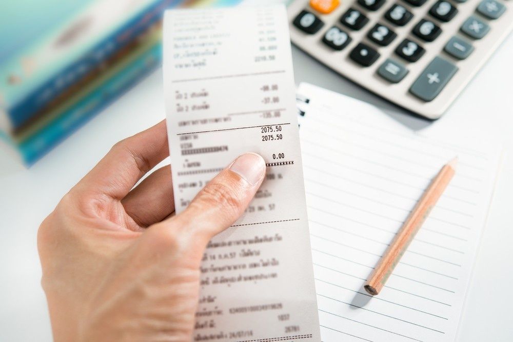 Person Holding a Receipt, with Calculator — Books in a Mess Australia in Terrigal, NSW