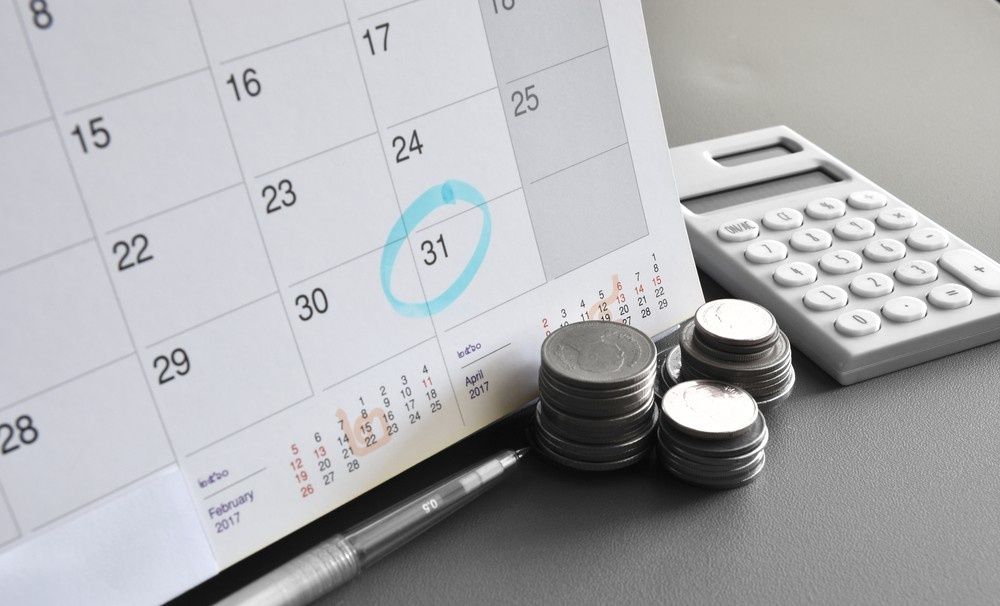 Calendar Open to The 31st with A Teal Circle, Coins, a Calculator, and A Pen — Books in a Mess Australia in Peats Ridge, NSW