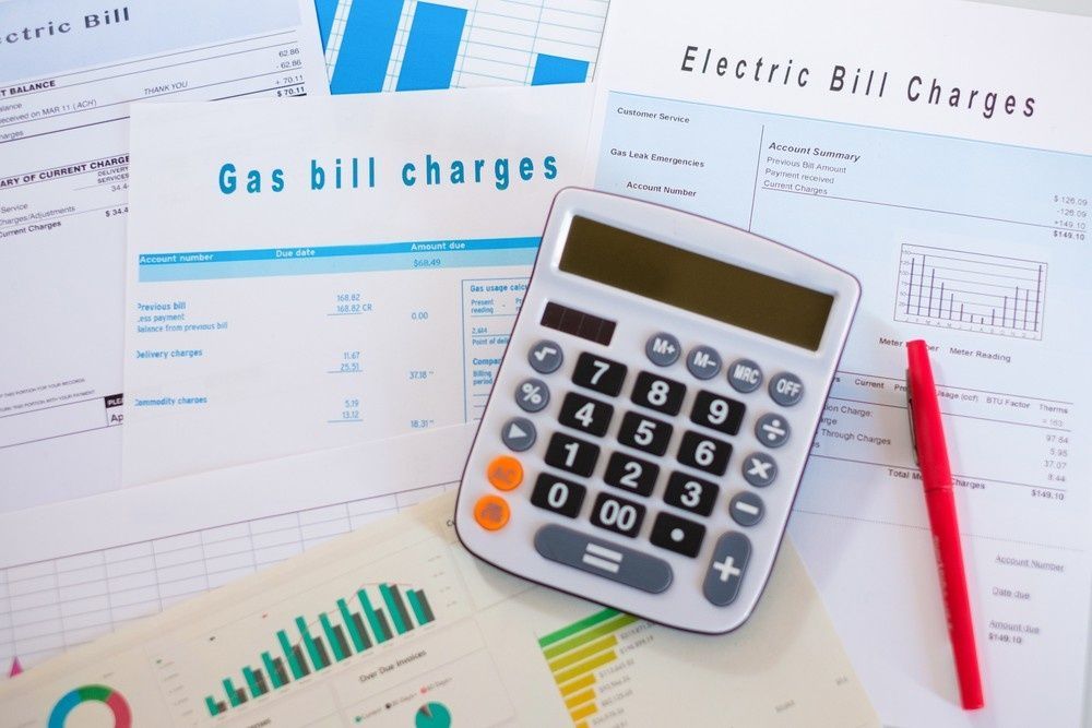 Calculator and Pen on Papers of Gas and Electric Bill Charges — Books in a Mess Australia in Peats Ridge, NSW