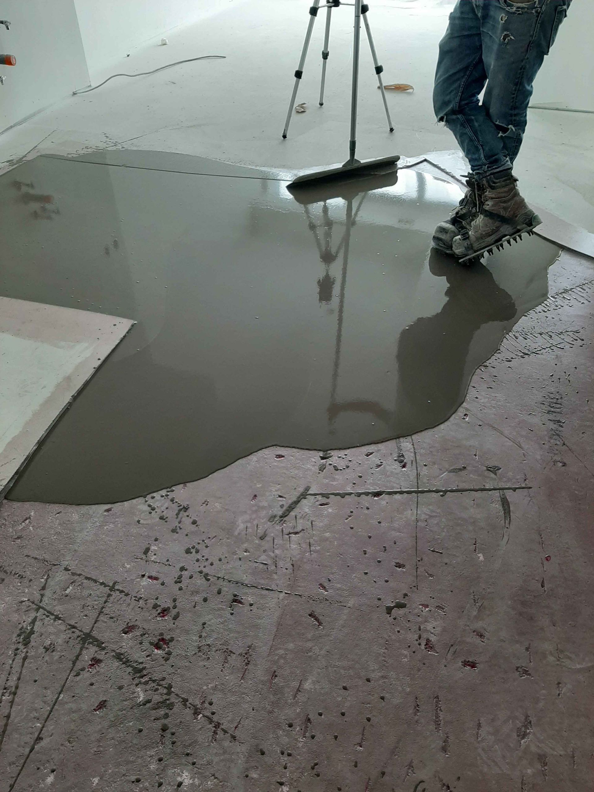 A person is standing in a puddle of liquid on the floor.
