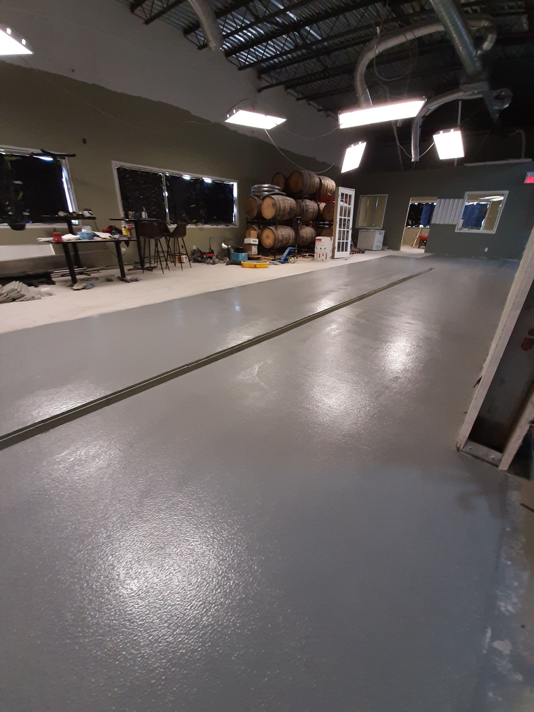 A large room with a lot of barrels on the floor.