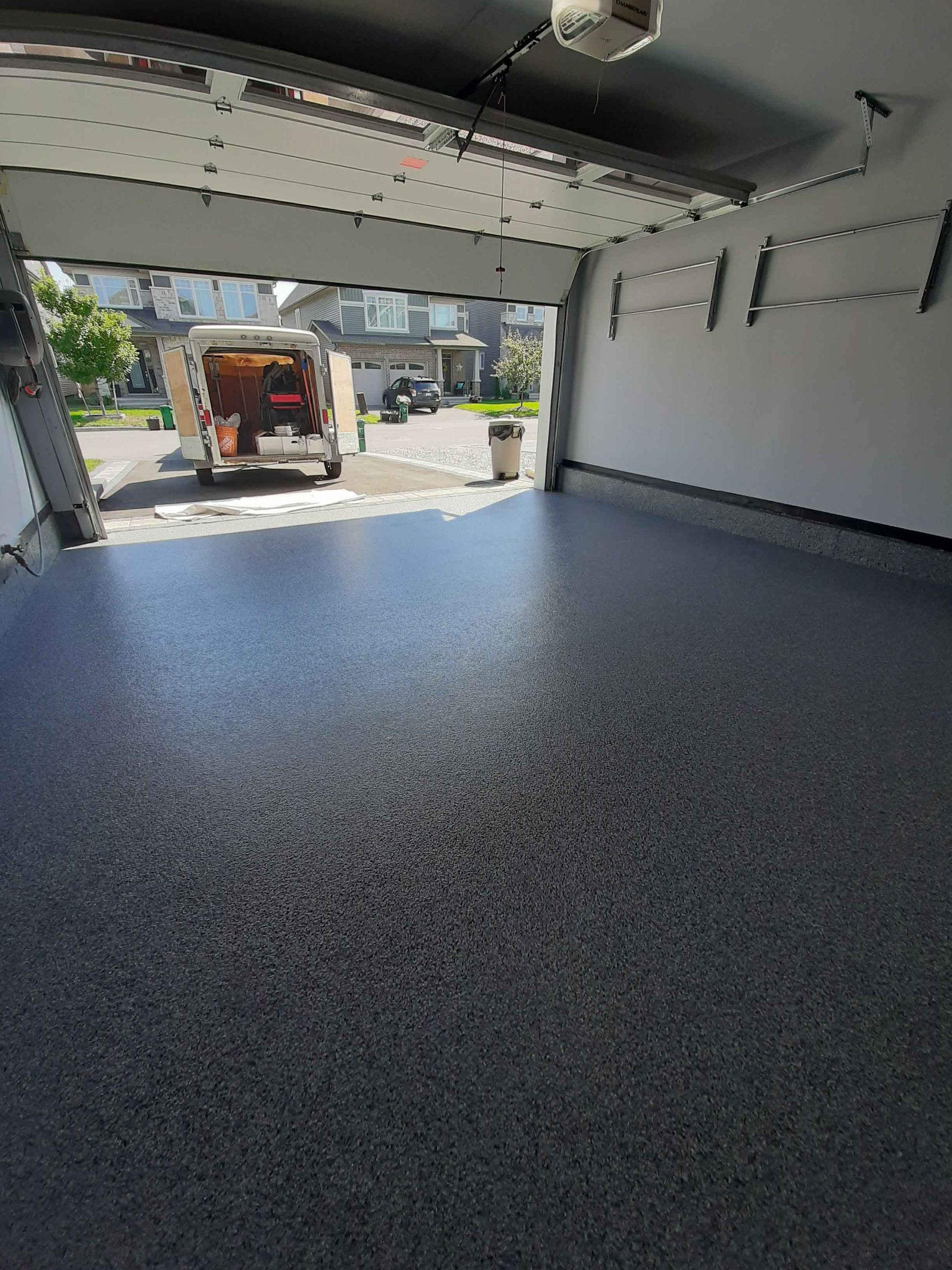 A van is parked in a garage with the door open.