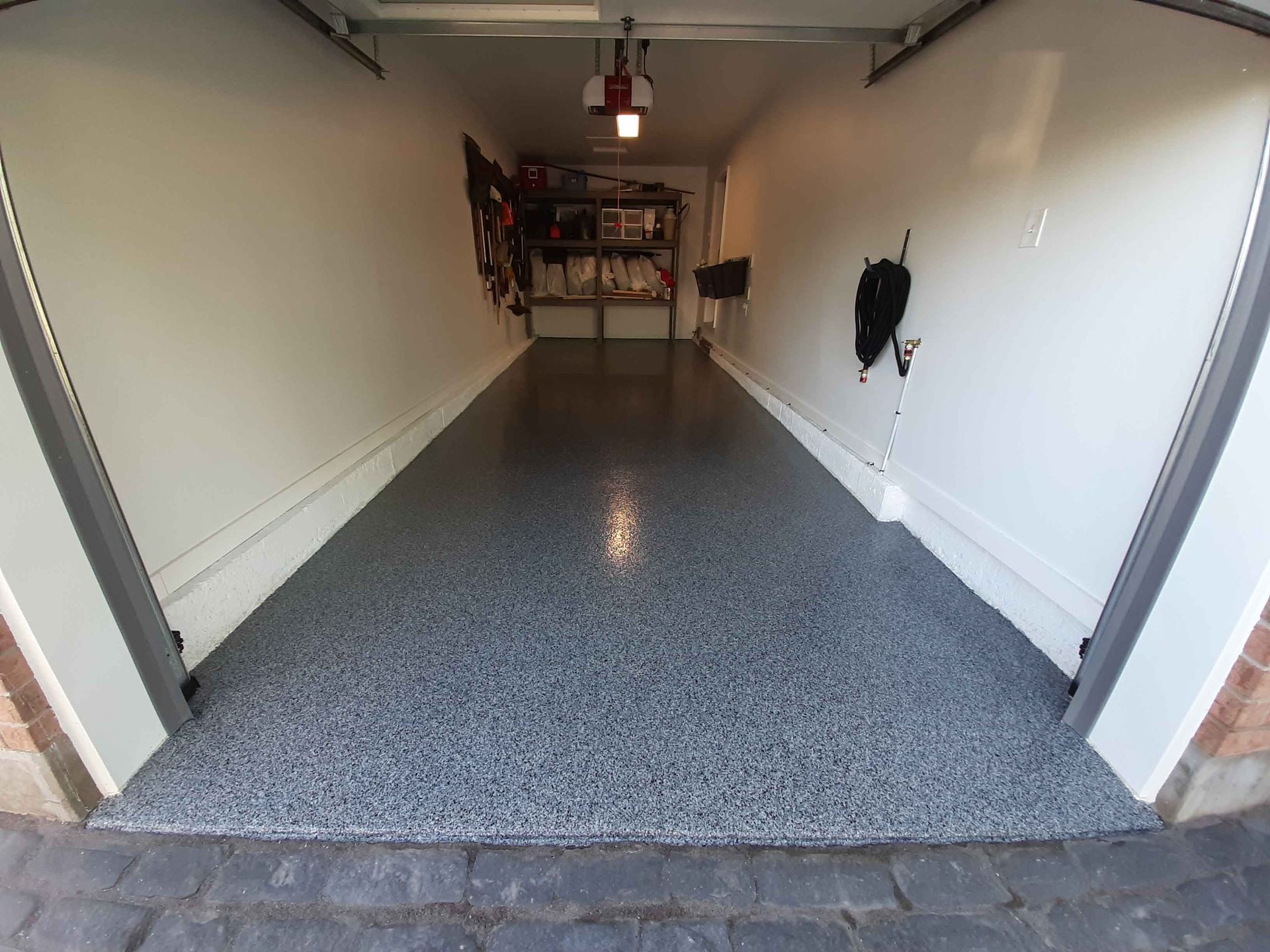 A garage with a gray floor and white walls