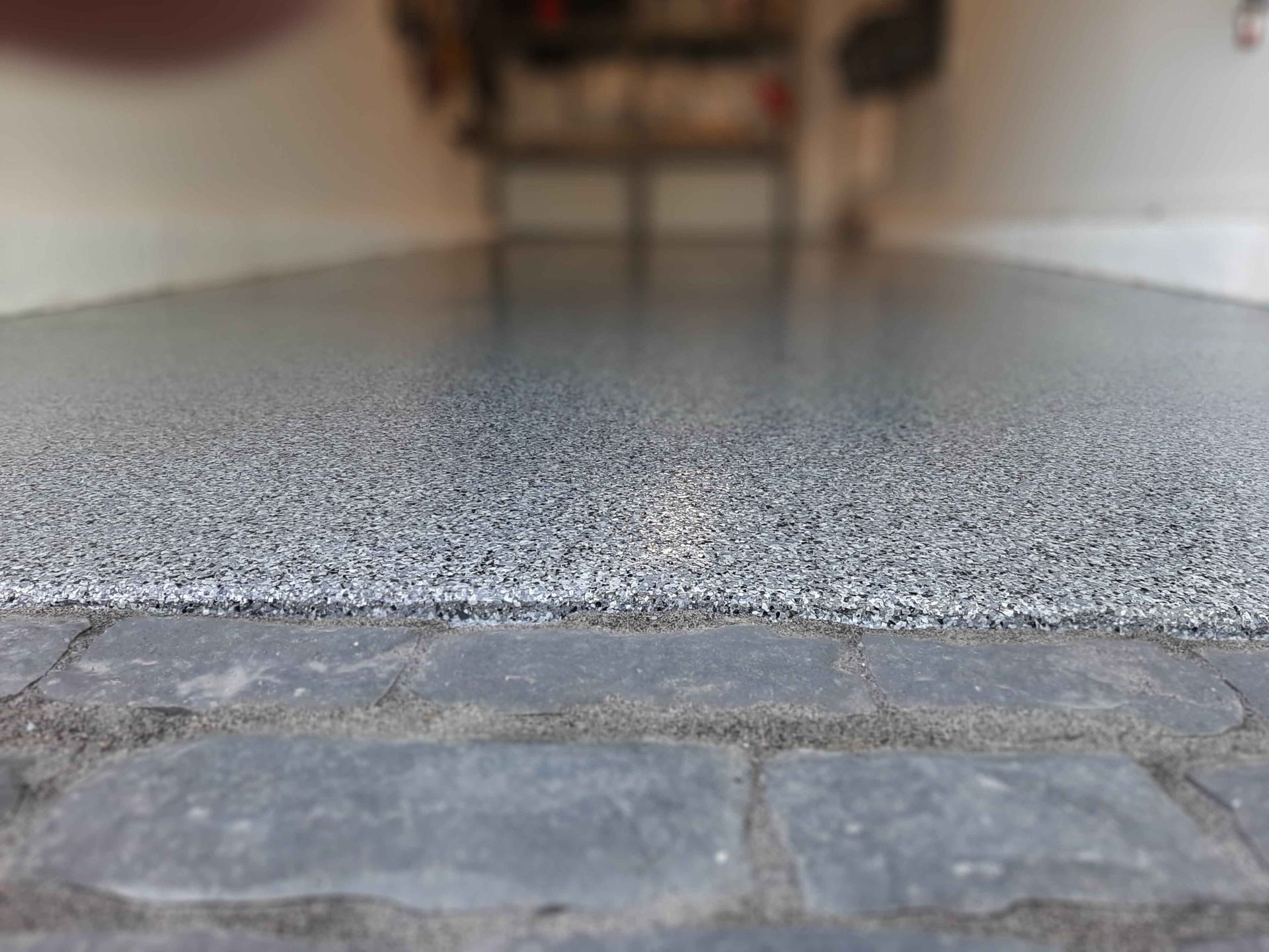 A close up of a concrete floor with a rug on it.