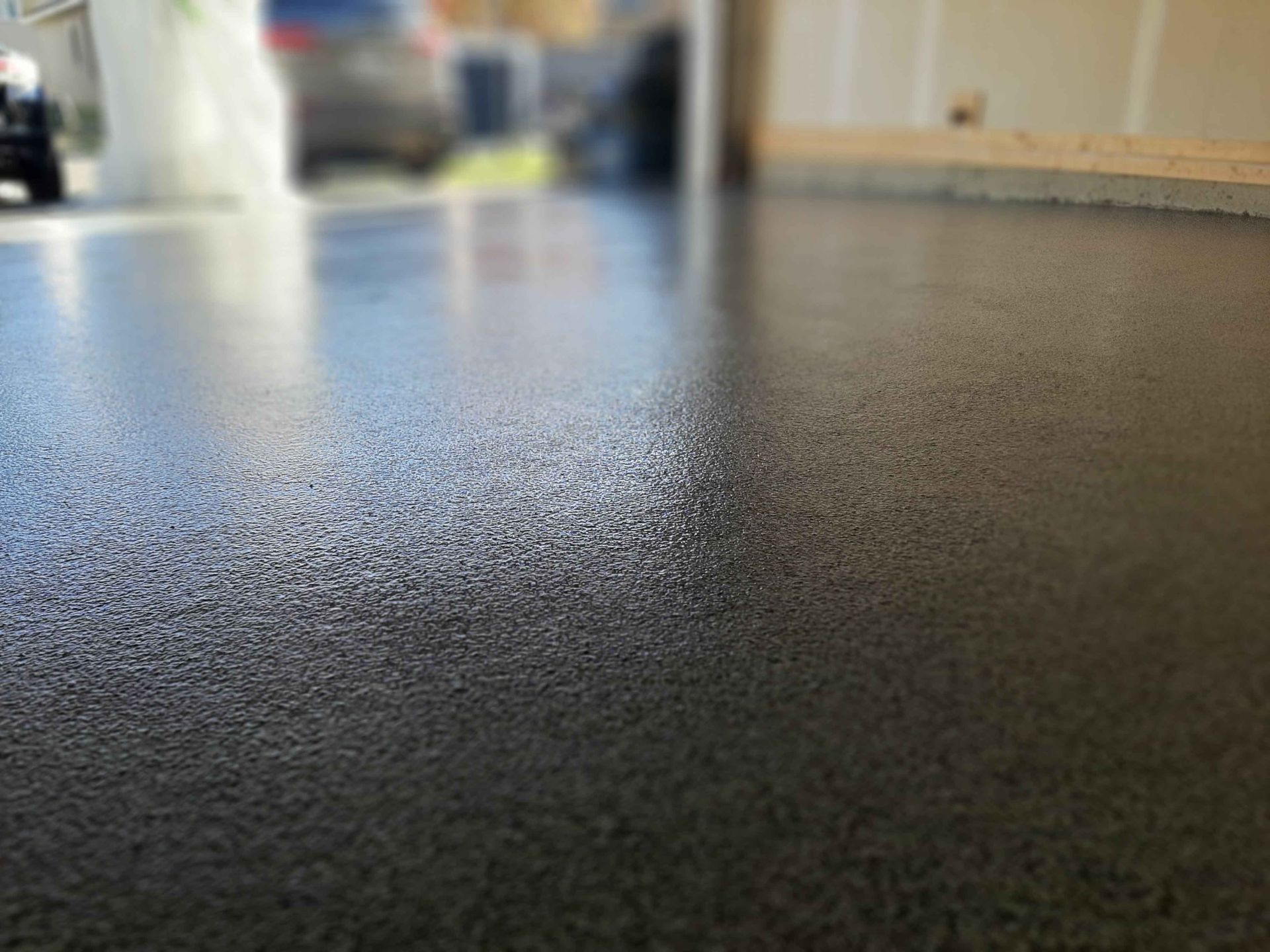 A close up of a black concrete floor in a garage.