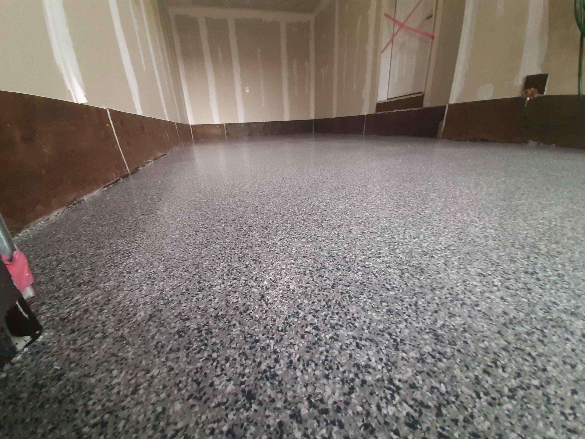 A close up of a gray concrete floor in a garage.