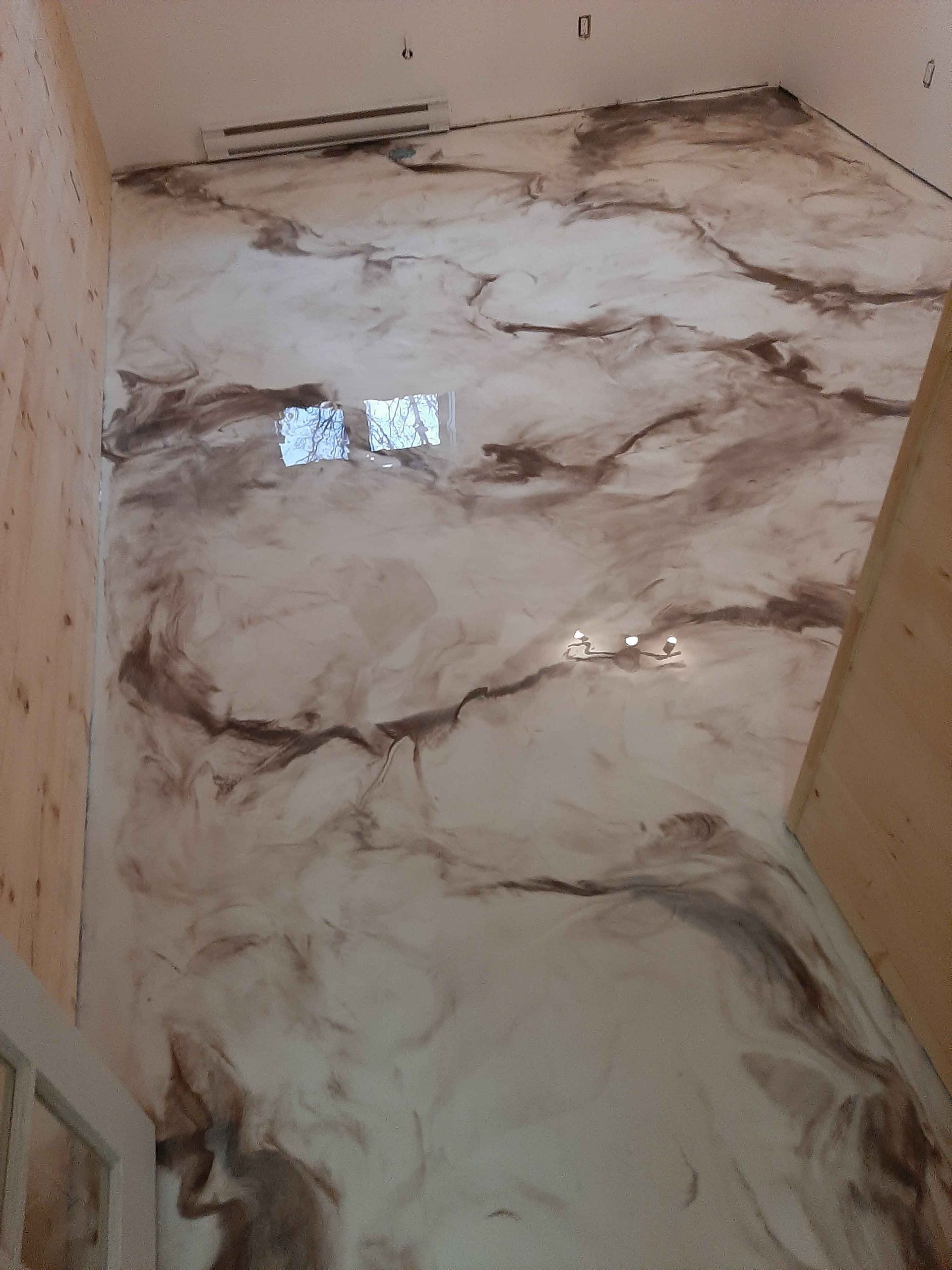 A room with a marble floor and a window.
