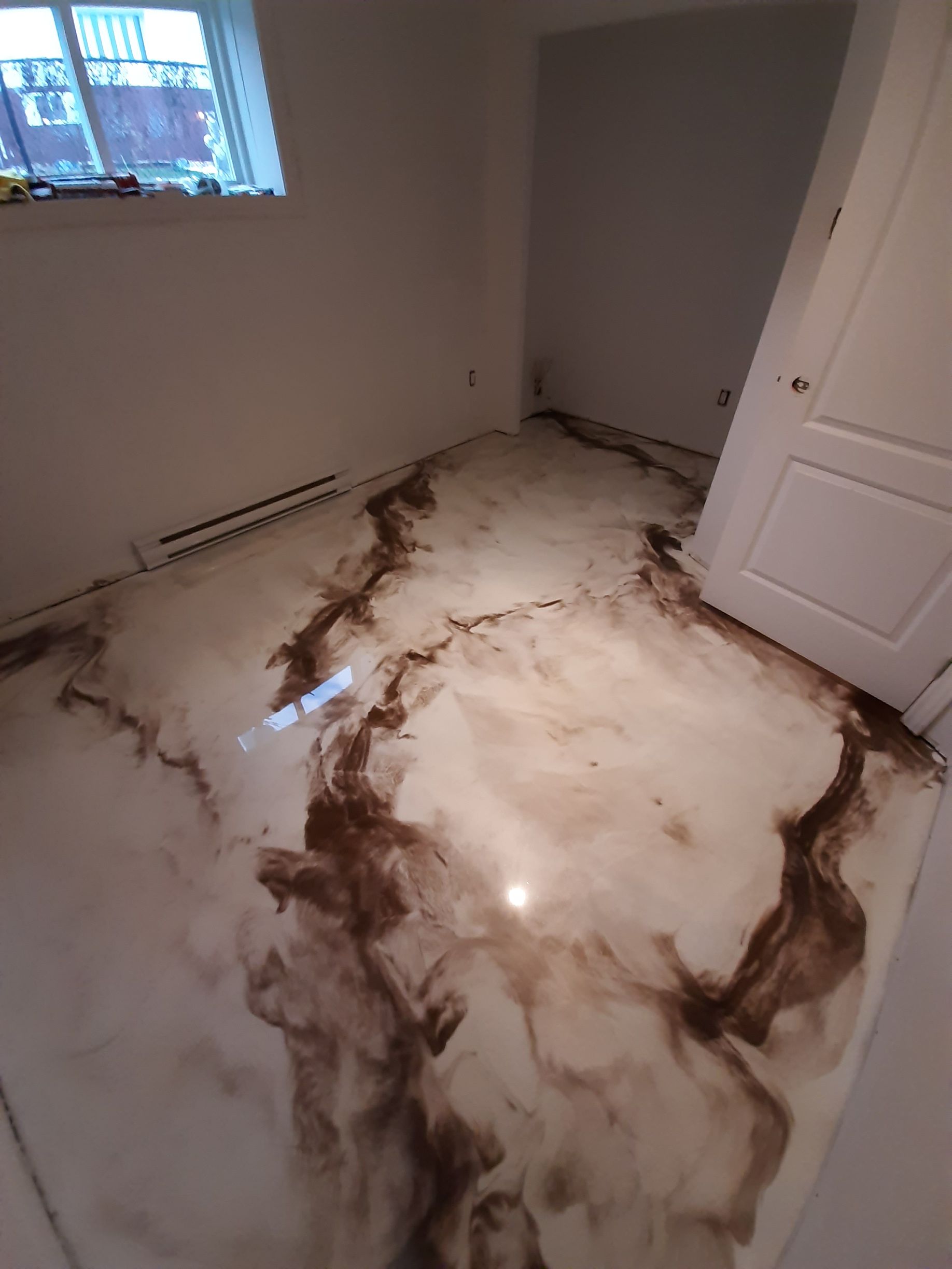 A room with a marble floor and a door.
