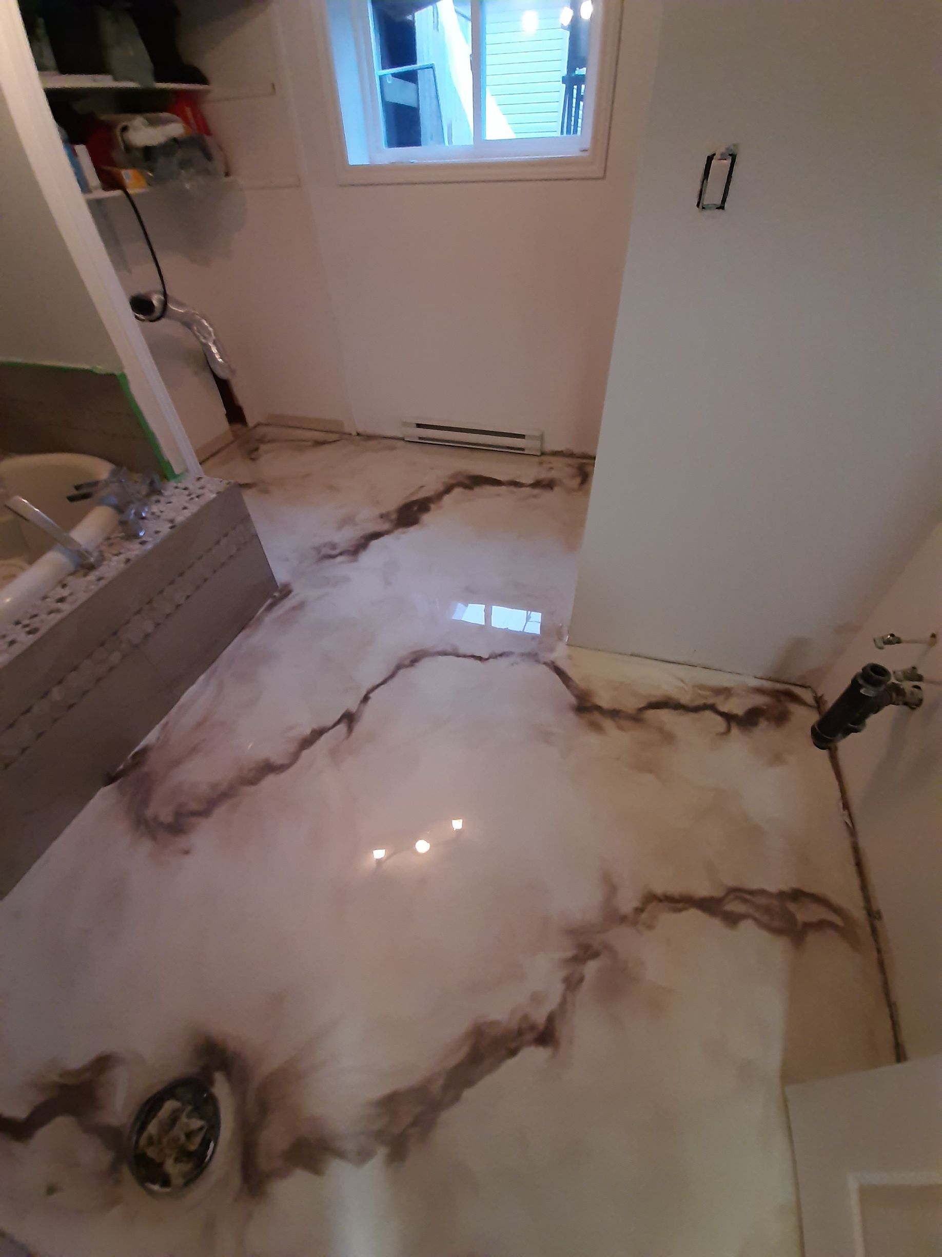 A bathroom with a marble floor and a sink