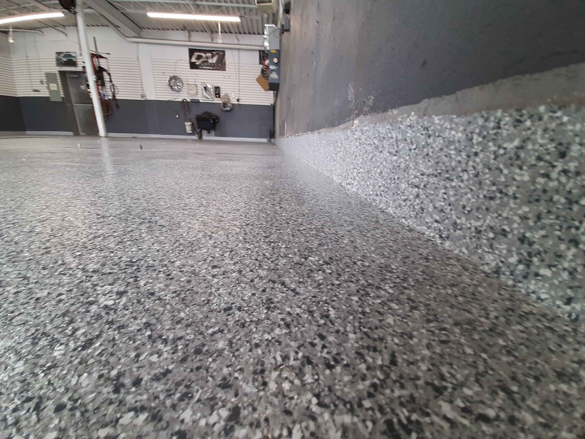 A close up of a gray concrete floor in a garage.
