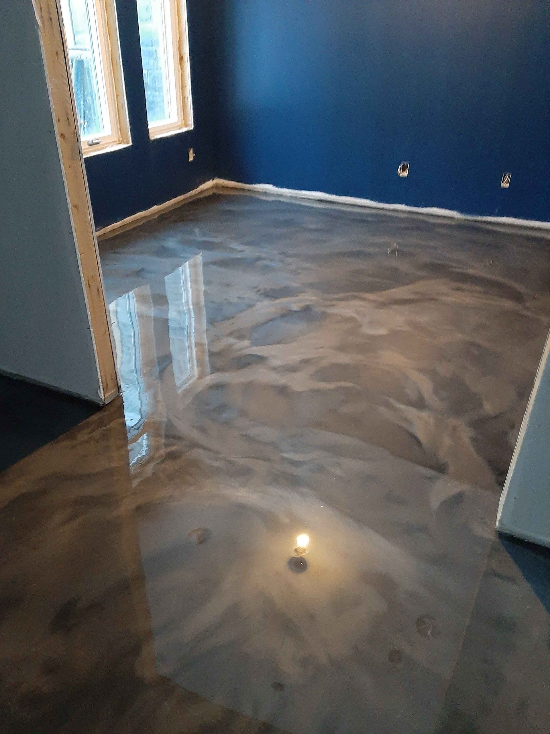 A room with a shiny metallic floor and blue walls.