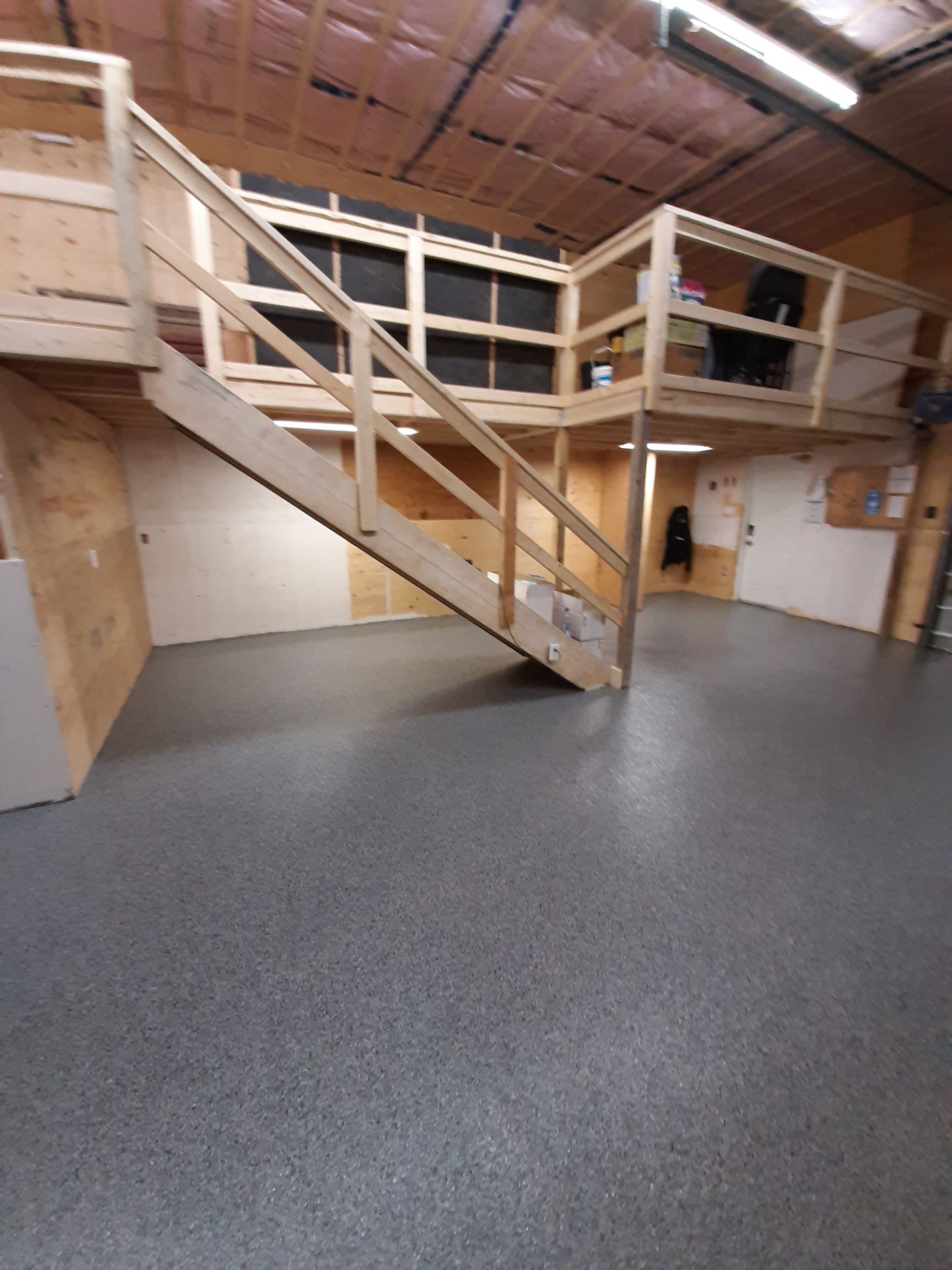 A room with stairs leading up to a second floor.