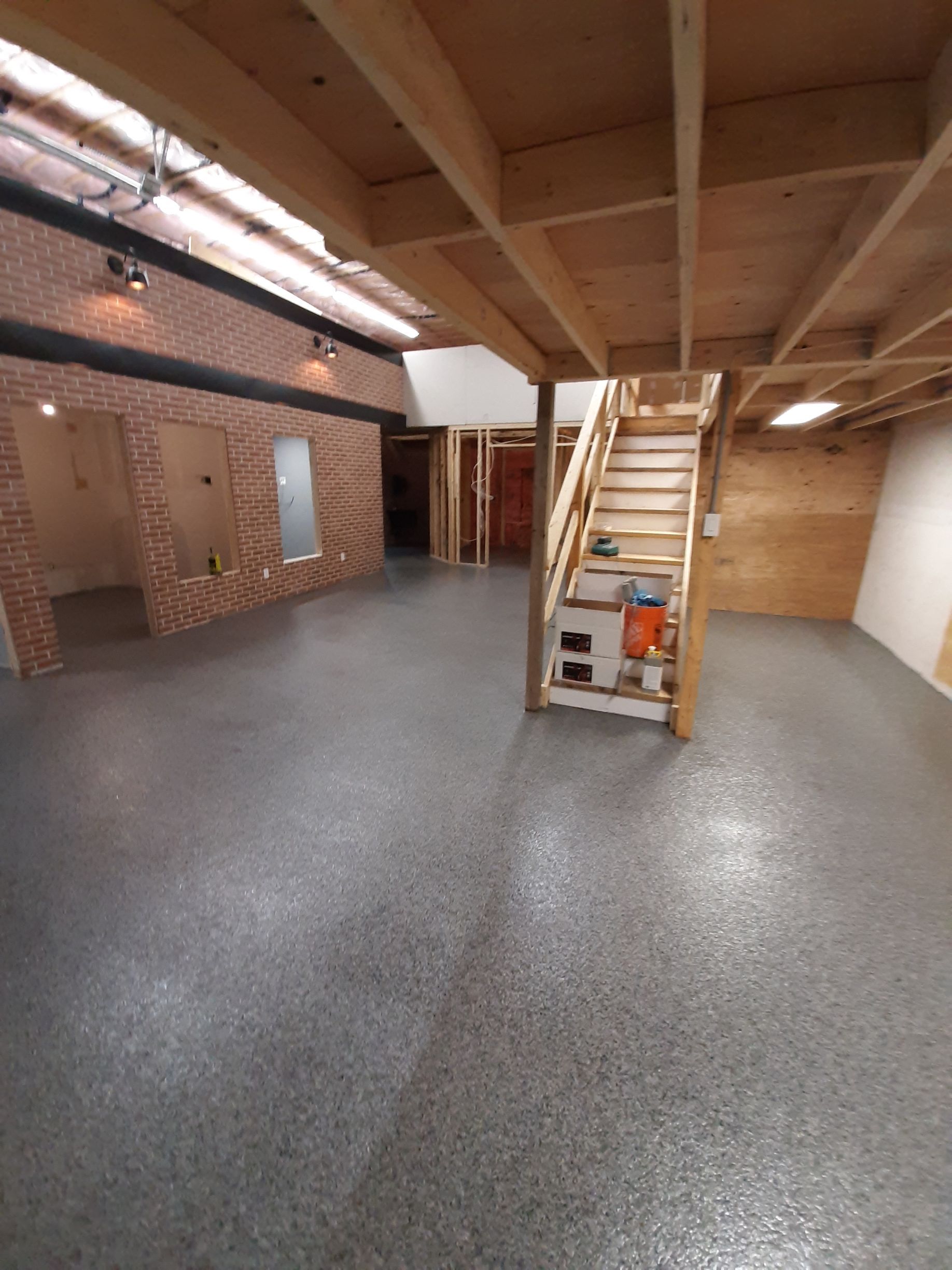 A garage with a staircase leading up to the second floor.