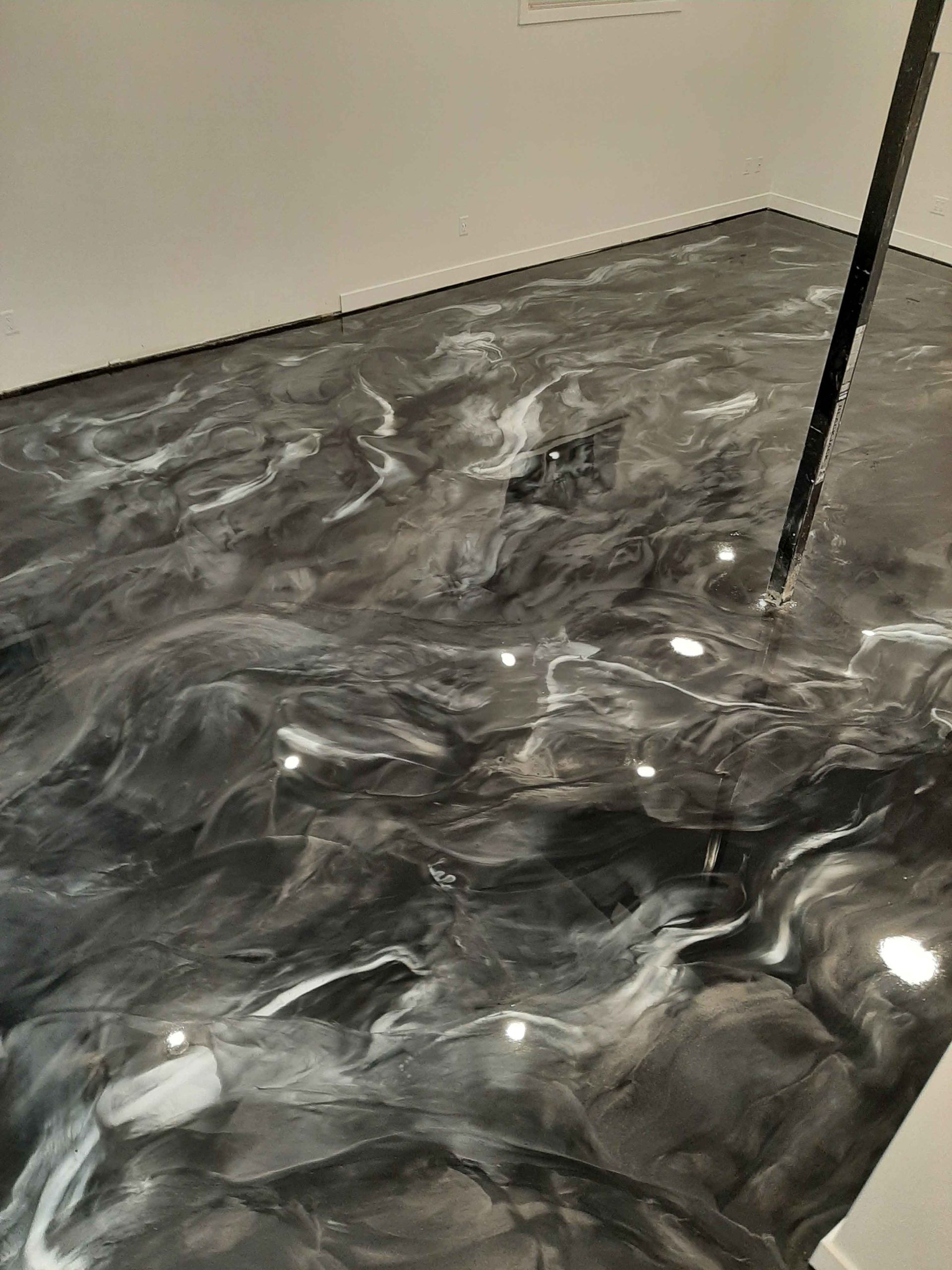 A close up of a black and white metallic floor in a room.