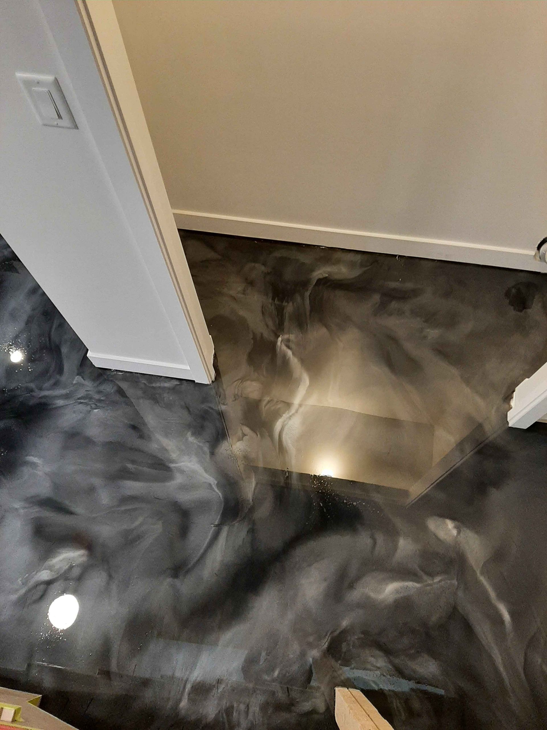 A black and silver metallic floor in a hallway.