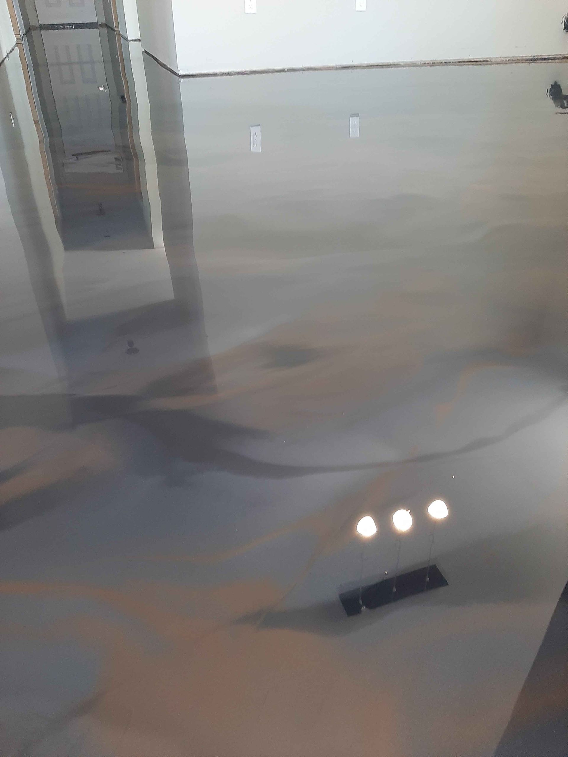 A close up of a shiny metallic floor in a room.