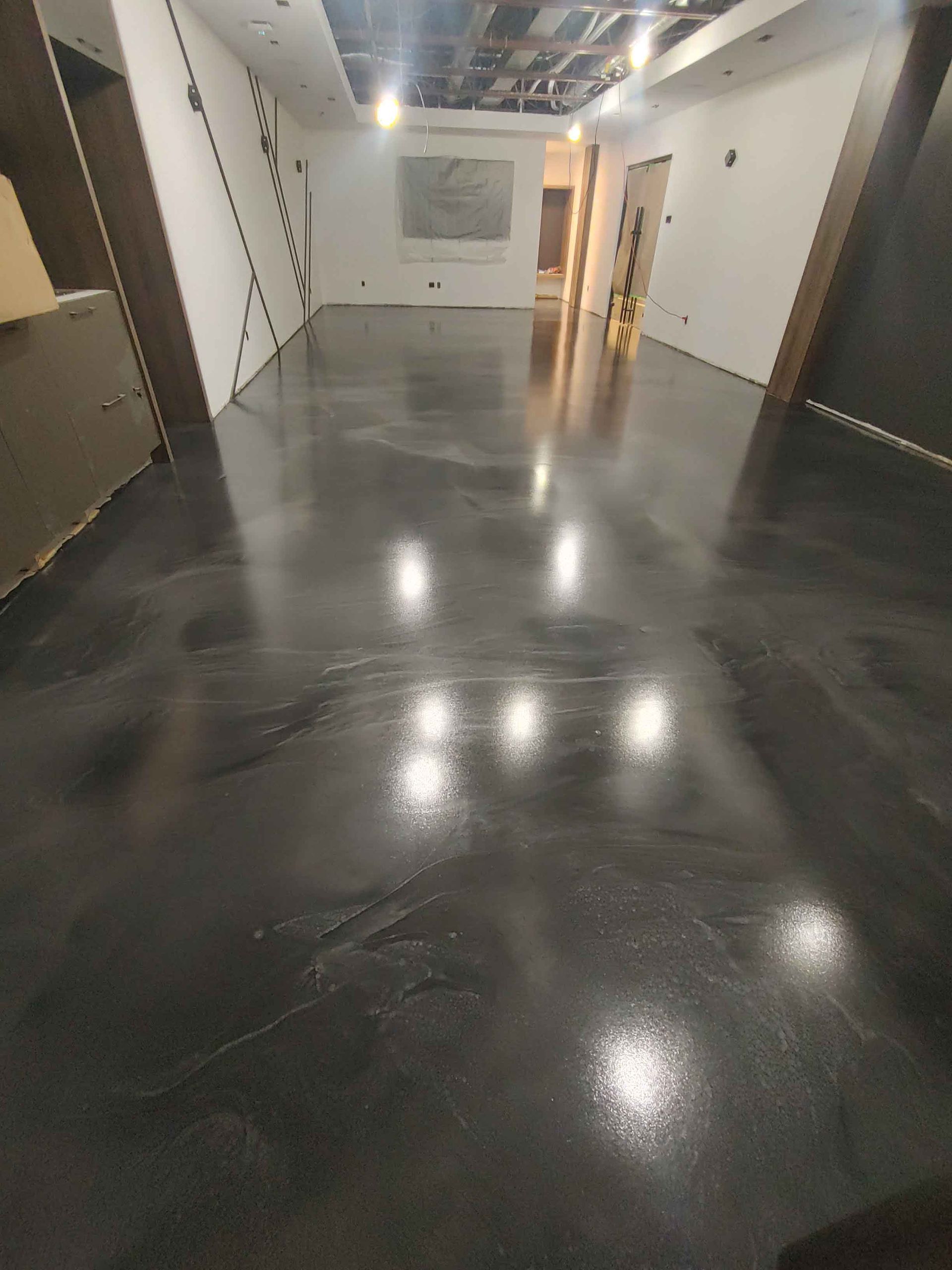 A large room with a black floor and white walls.