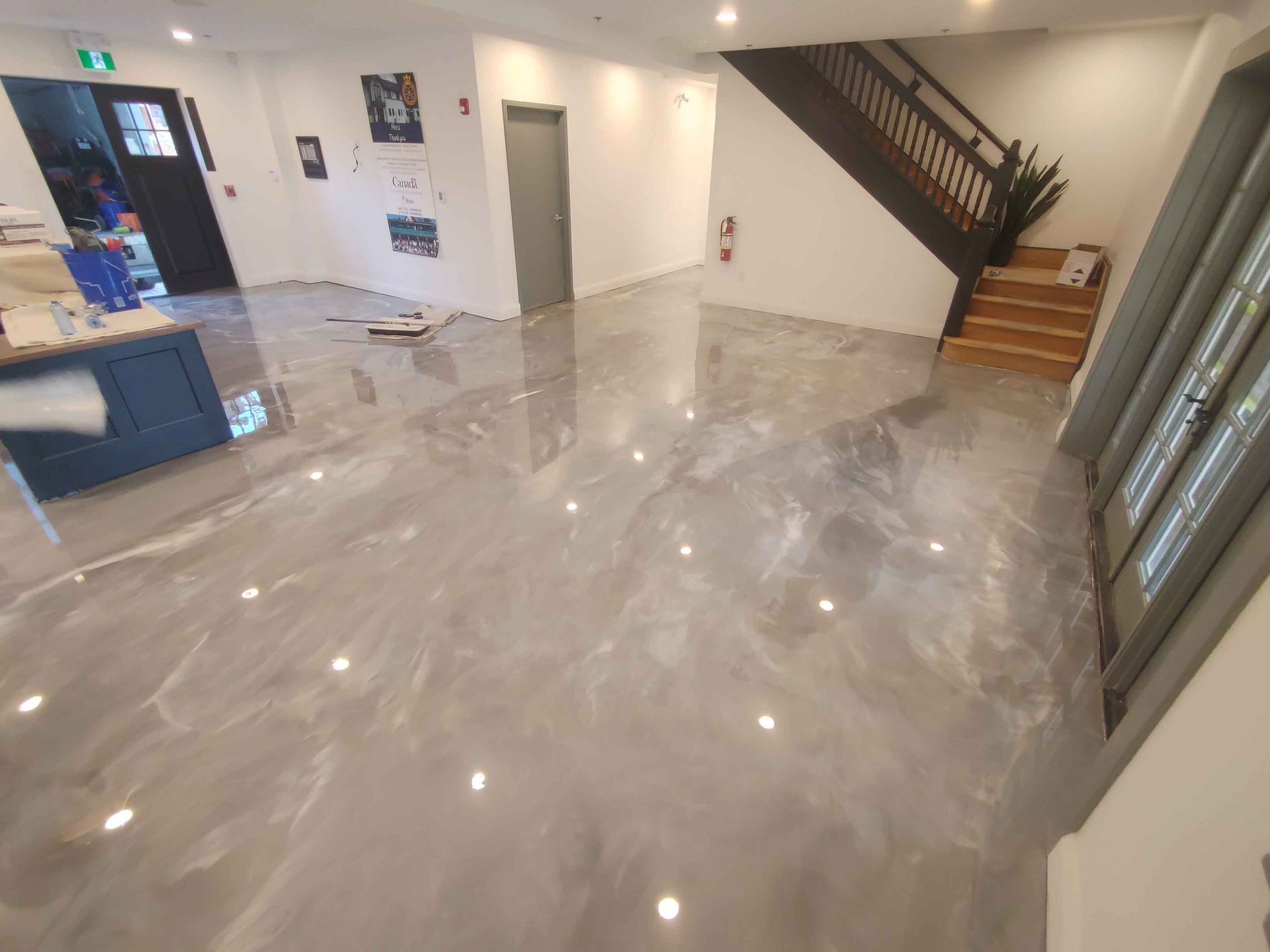 A large room with a staircase and a shiny floor.