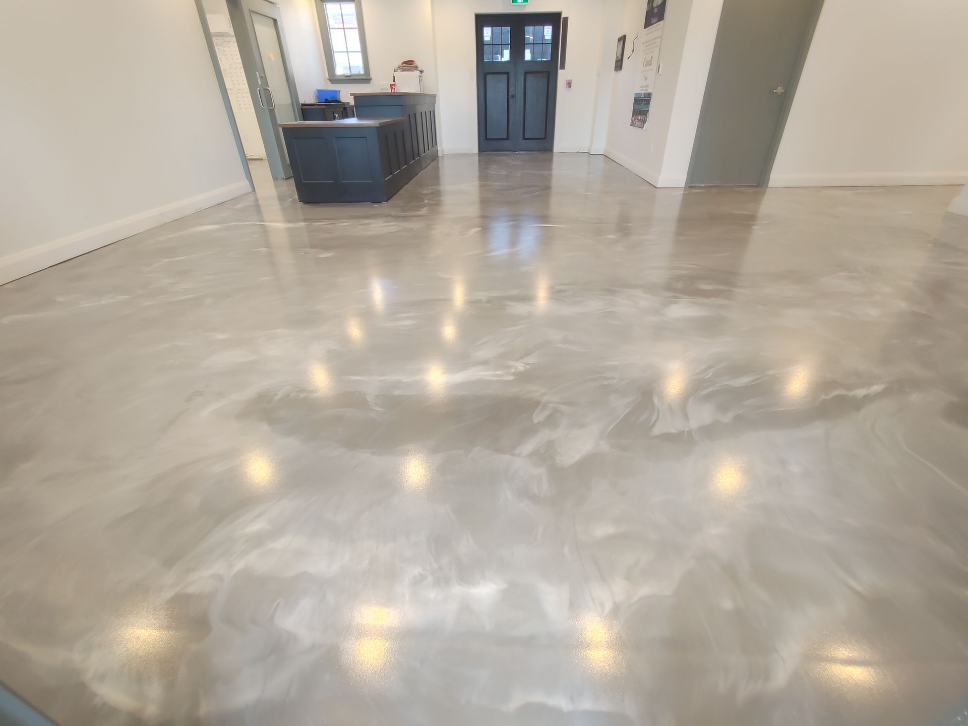 A large room with a shiny concrete floor