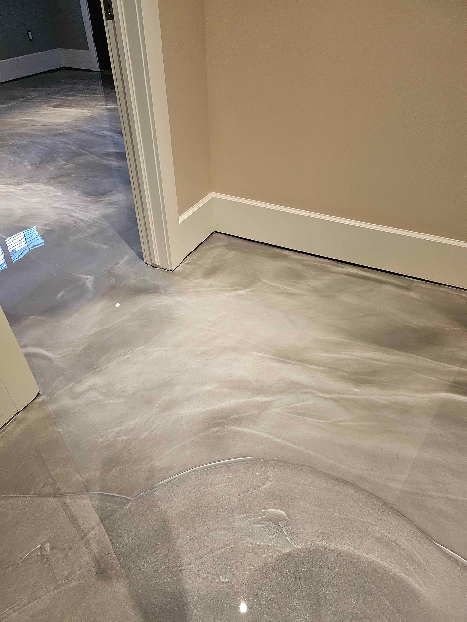 A room with a concrete floor and a door.