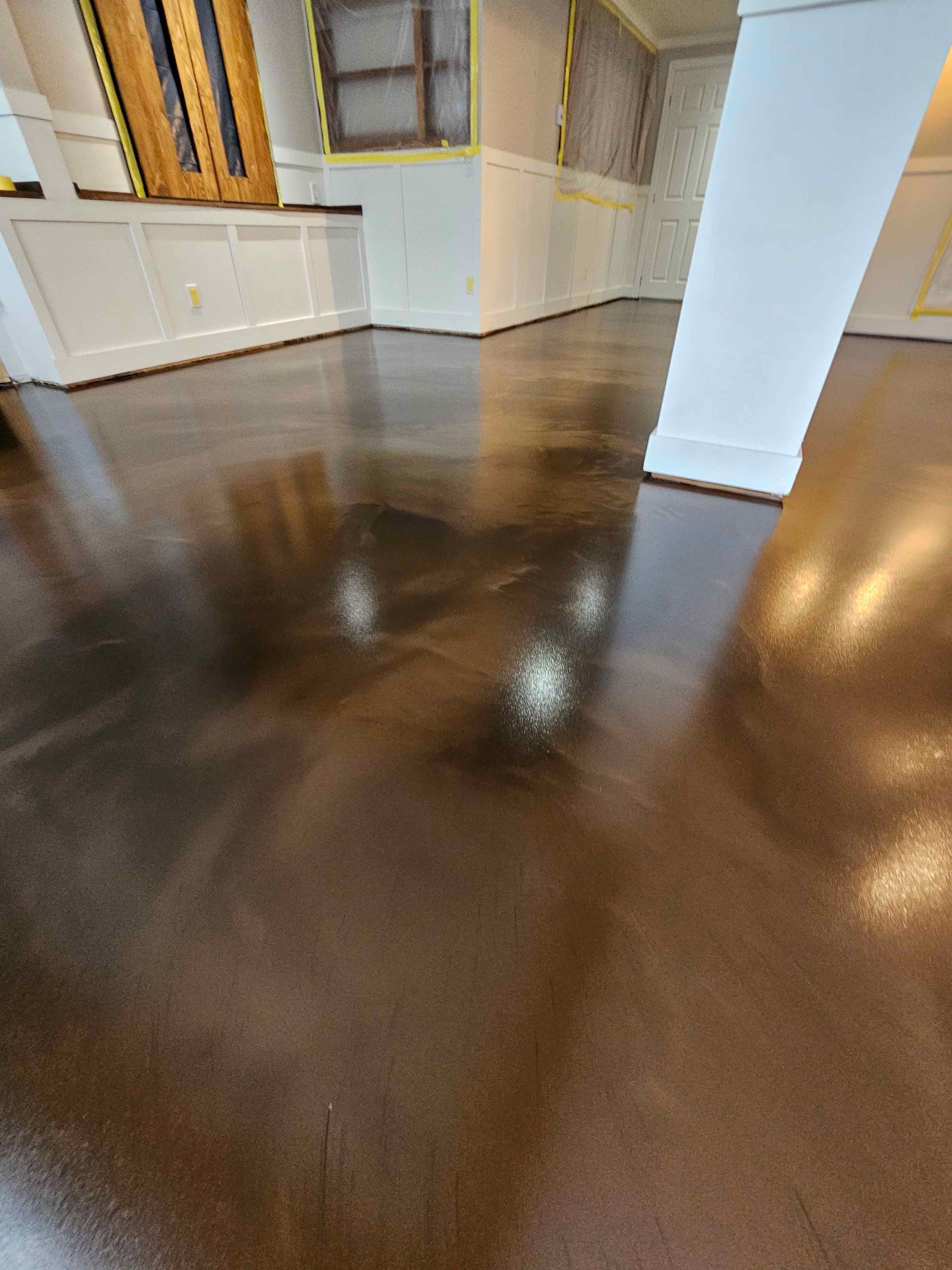 A close up of a shiny concrete floor in a room.