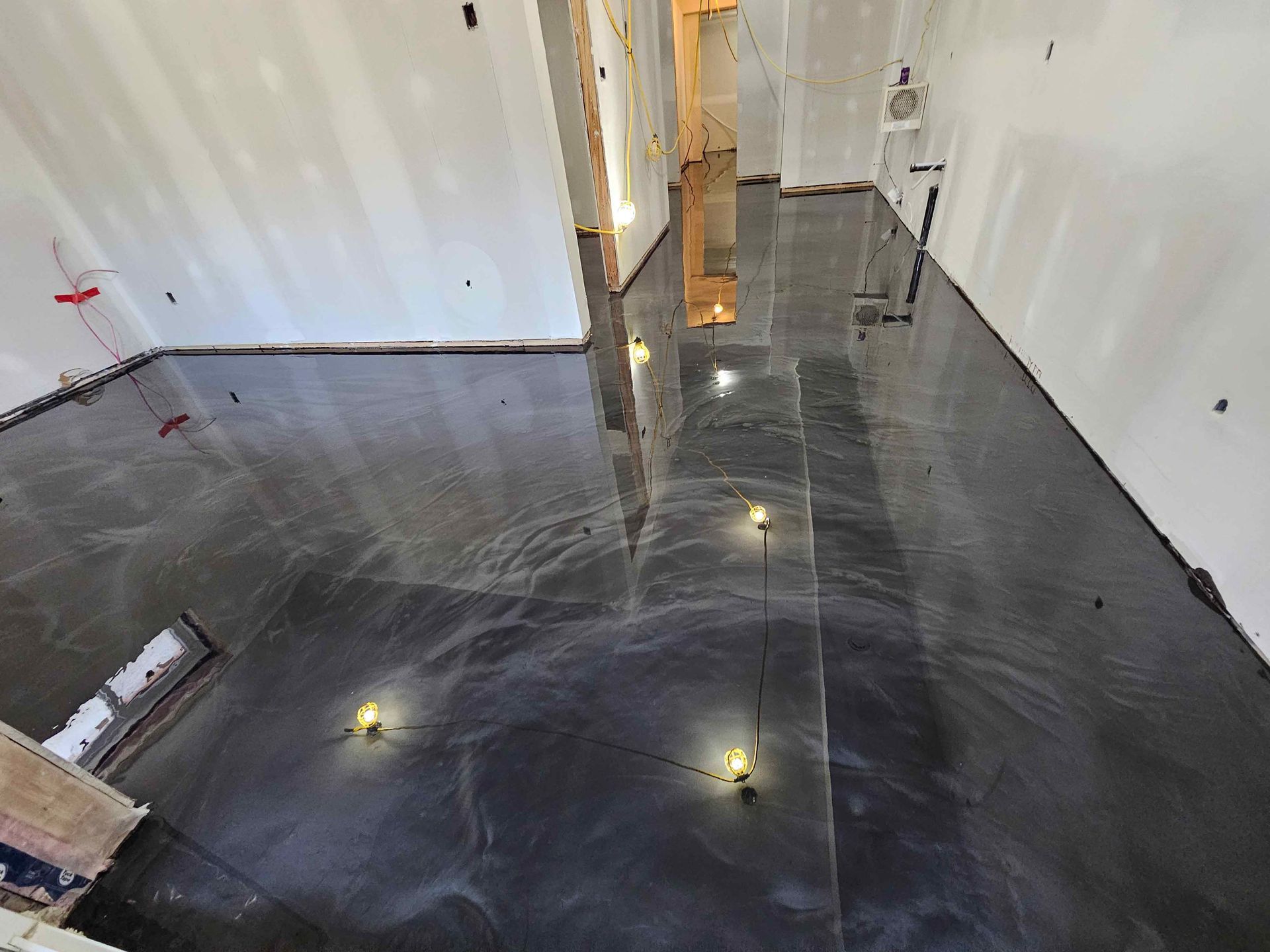 A room with a black floor and white walls.