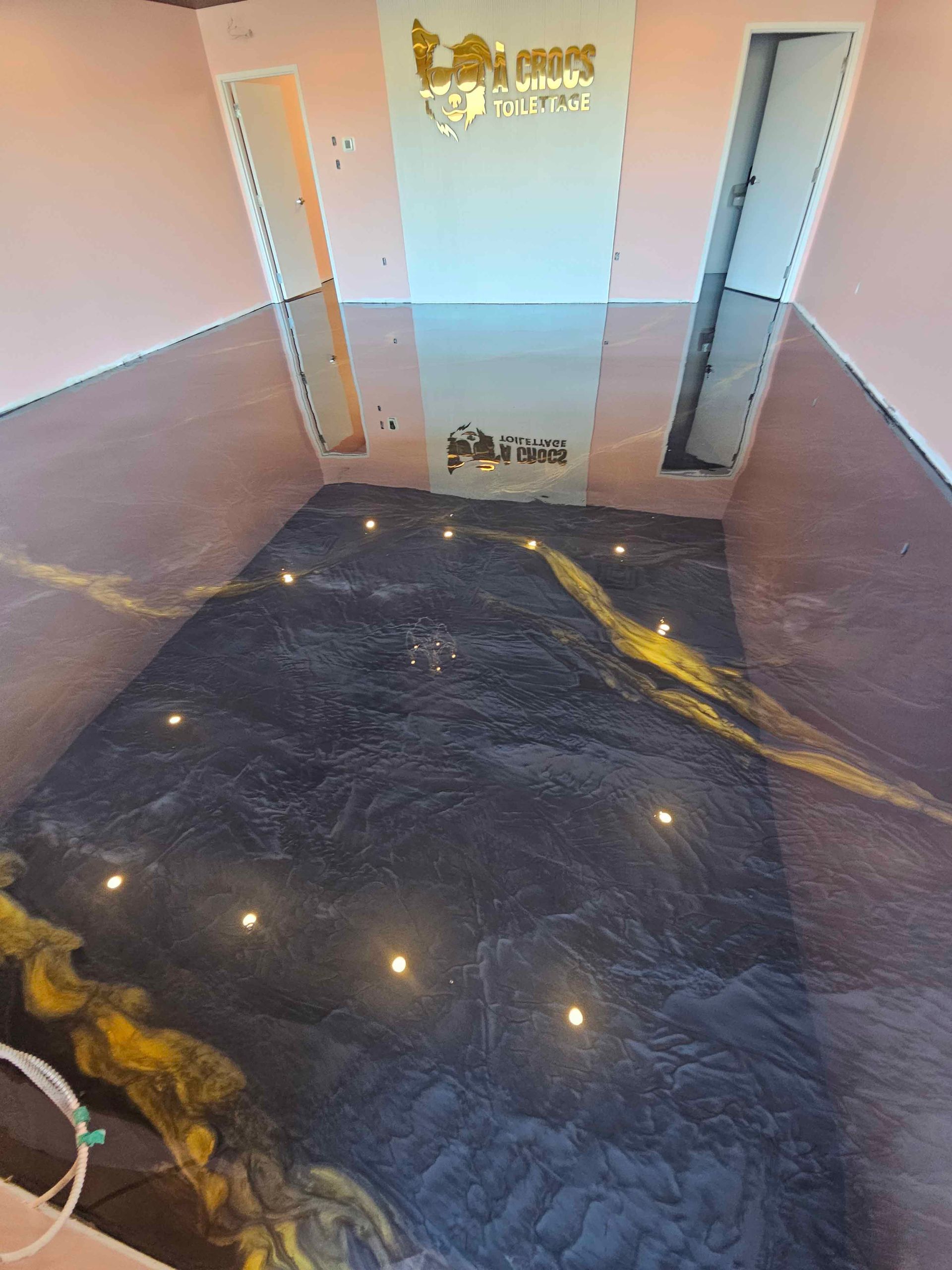 A room with a floor that looks like a pool with lights on it.