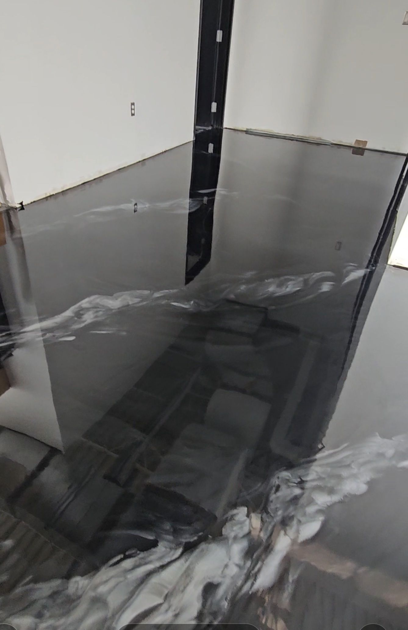 A close up of a black concrete floor in a room.