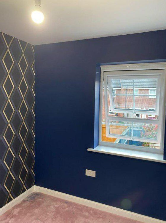 Picture of a kids bedroom with dark blue painted walls and feature wallpaper on one wall carried out by painters and decorators Glasgow