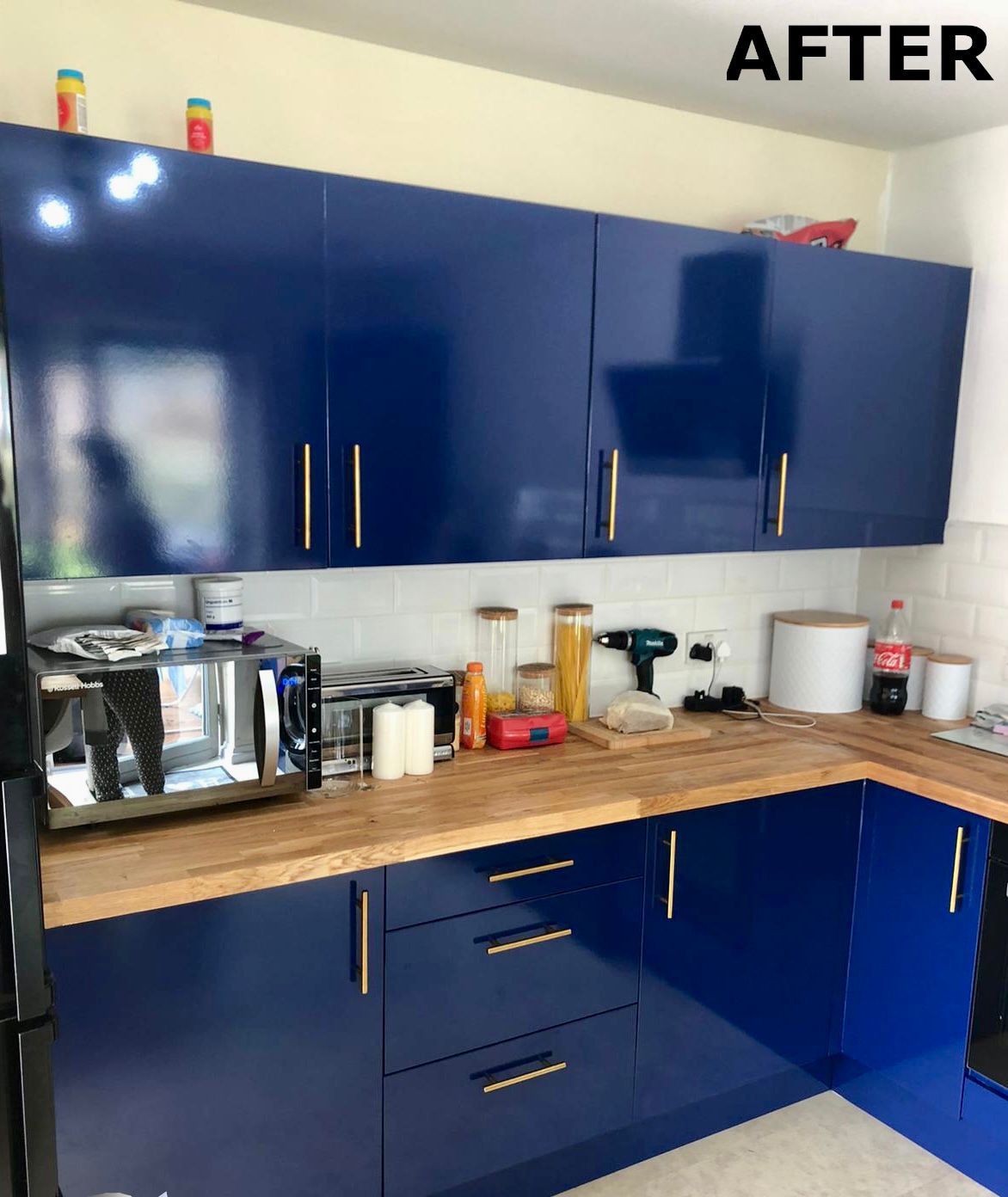 Kitchen units wrapped in high gloss midnight blue vinyl laminate by painters and decorators Glasgow
