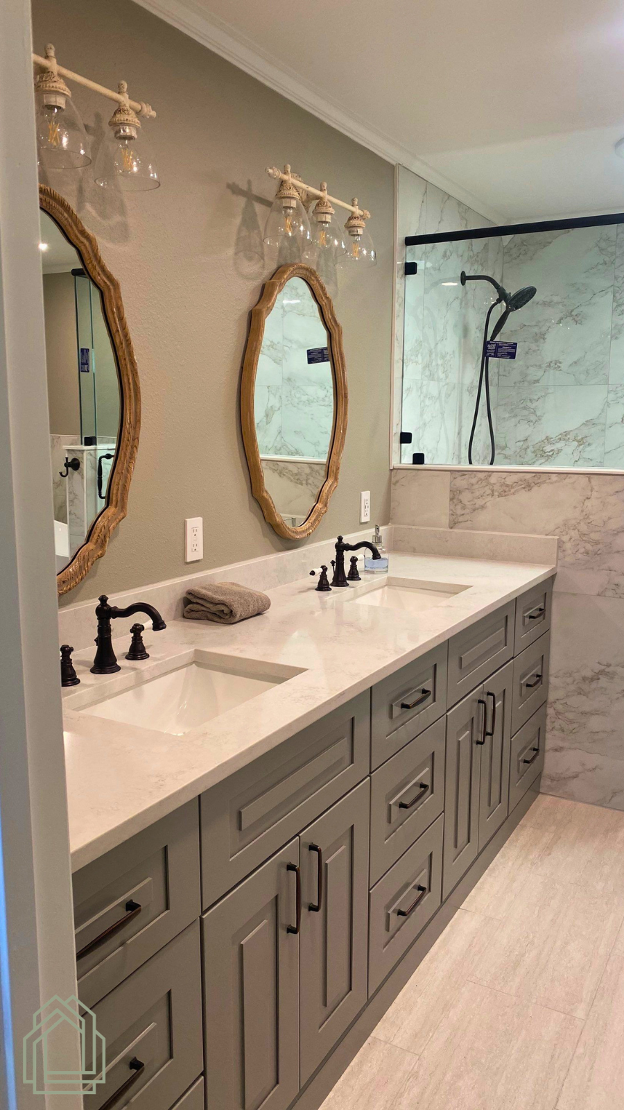 Modern bathroom vanity with dual sinks, oval mirrors, black faucets, and marble accents