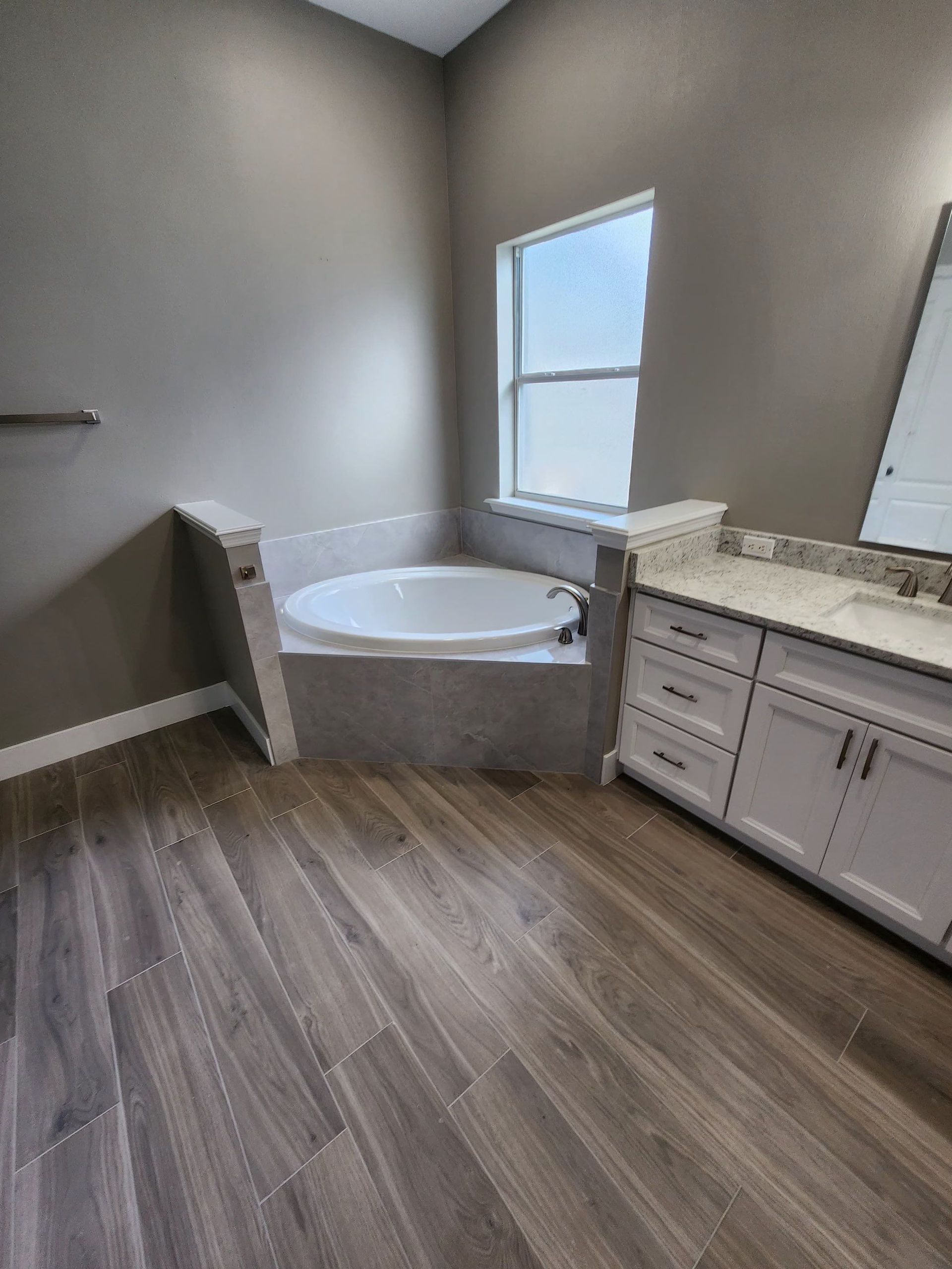 Bathroom tub and wall remodeling project in Lakeland FL with neutral paint and natural lighting