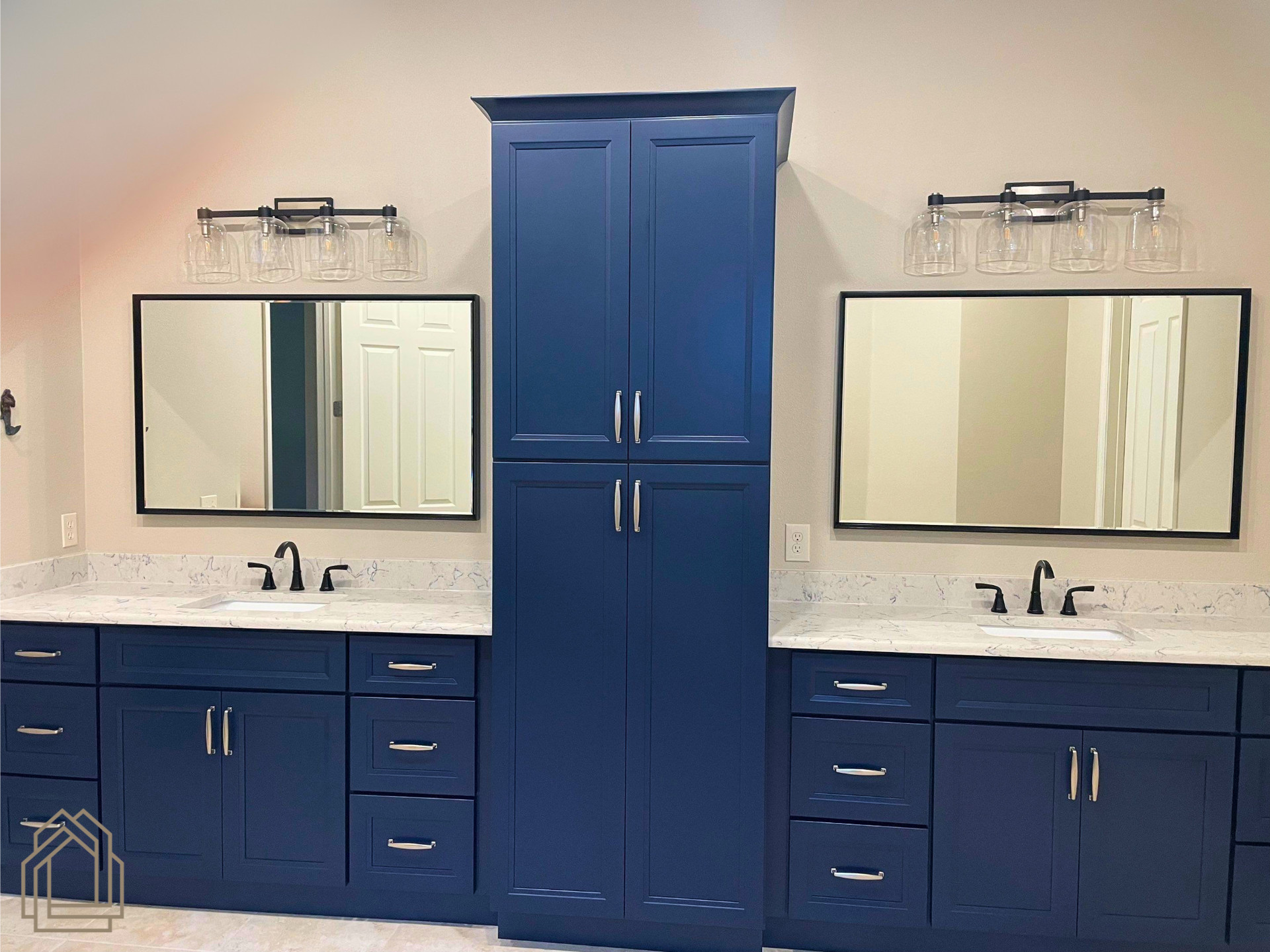 Blue double-sink bathroom vanity with mirrors and central cabinet against a light wall