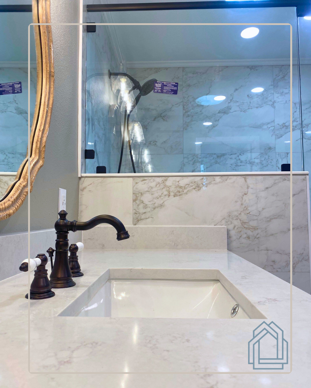 Modern bathroom vanity with white countertop, black faucet, and large mirror.