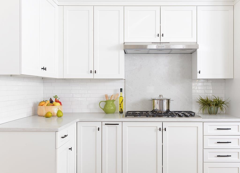 White shaker stock kitchen cabinets installed in a bright modern kitchen.
affordable, in stock kitchen cabinets