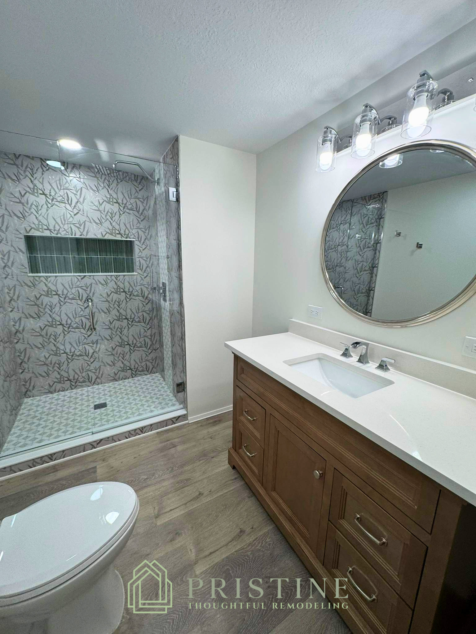 Bathroom vanity and mirror remodeling project in Lakeland FL with decorative wall tile and modern lighting