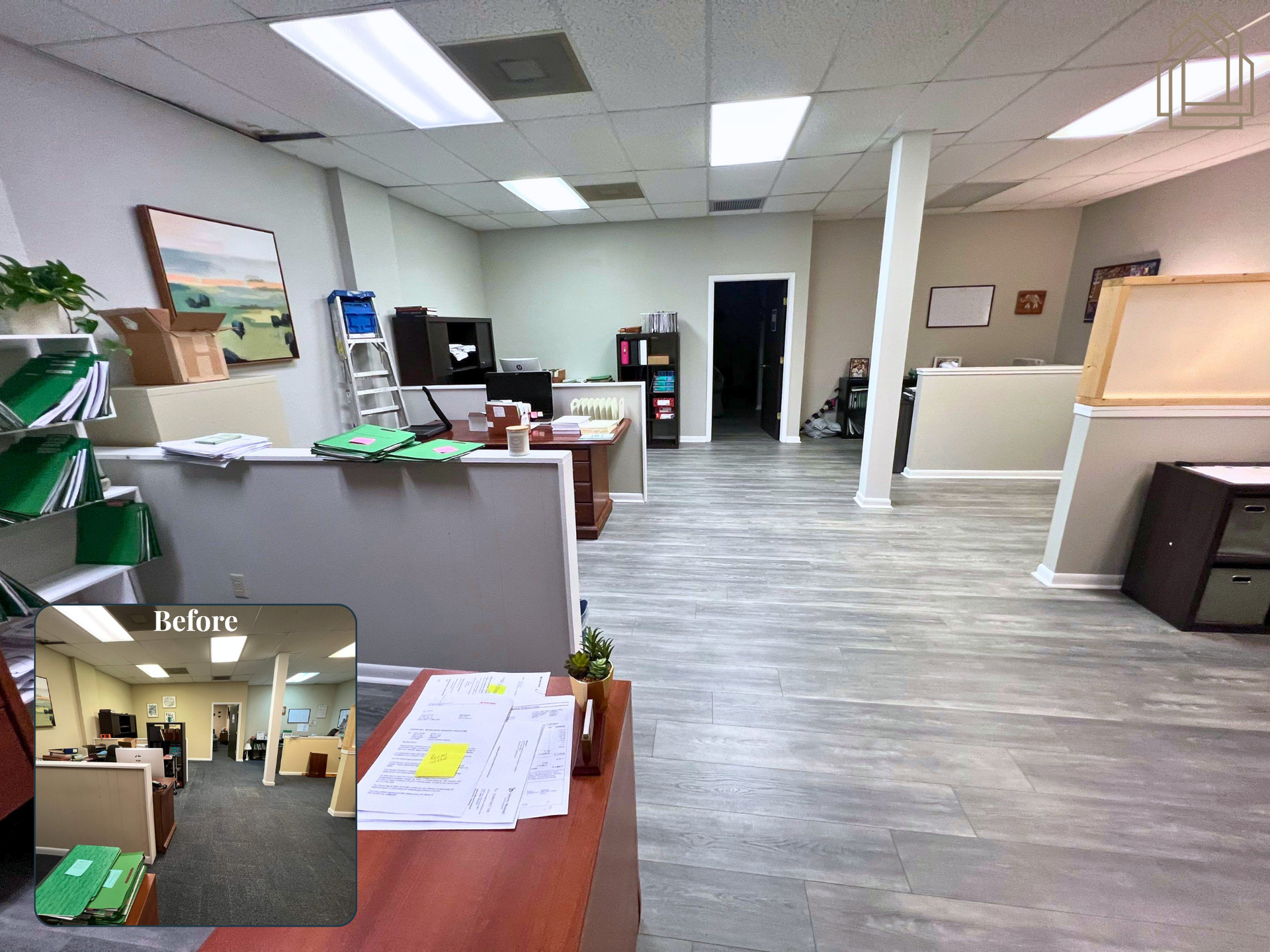 Office lobby with desks, chairs, vending machines, and a whiteboard in a bright, open hallway