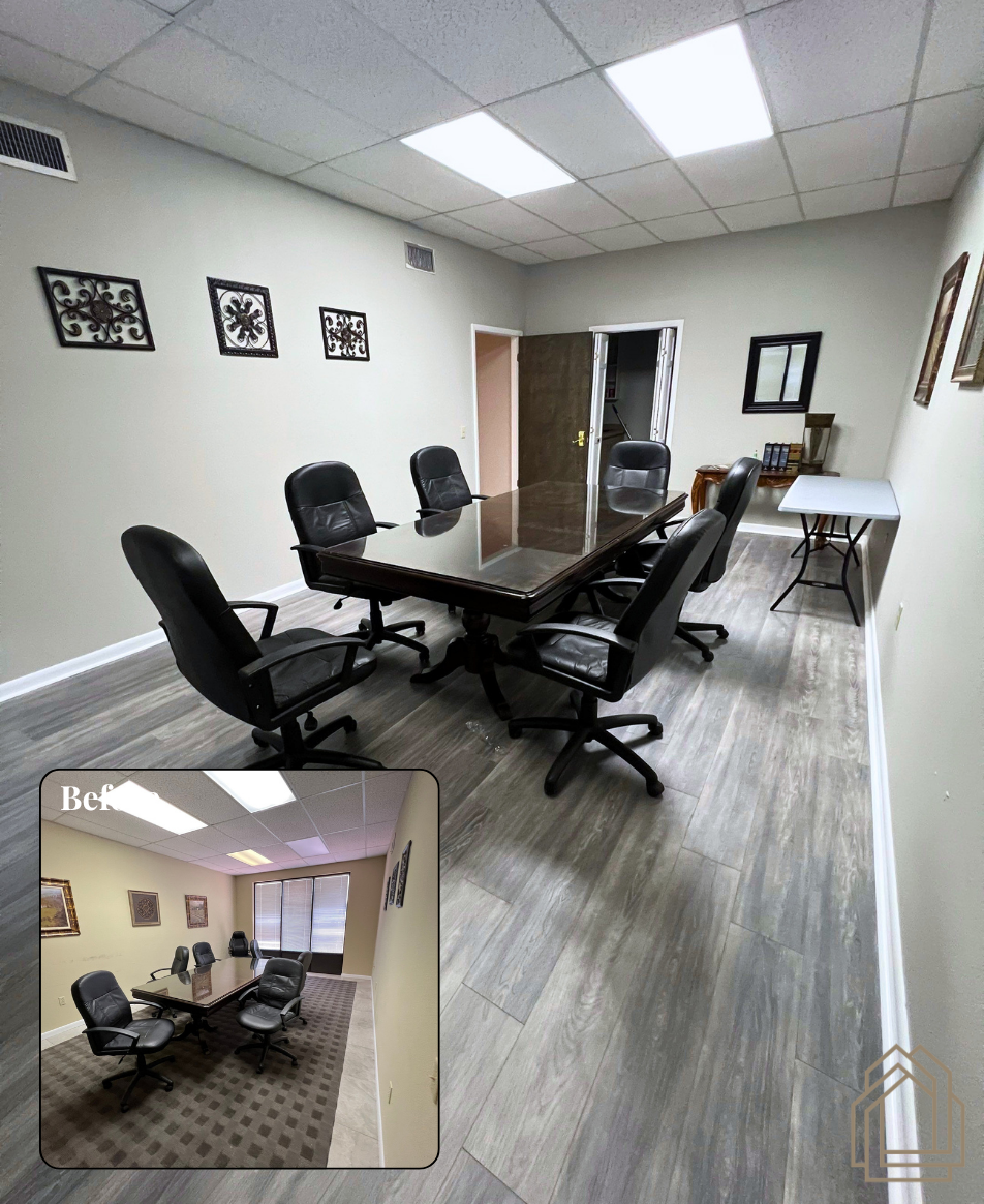 Conference room with black chairs, glass table, wall art, and a small inset view of the space