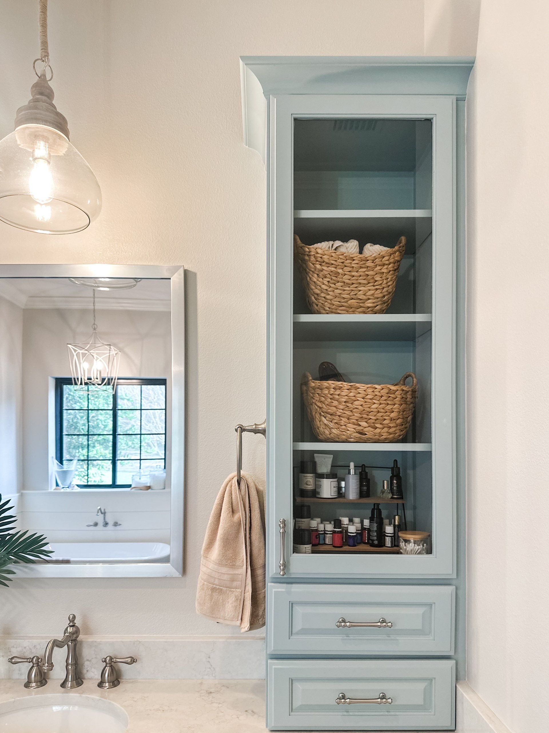Custom bathroom storage cabinet installation in Lakeland FL with decorative lighting
