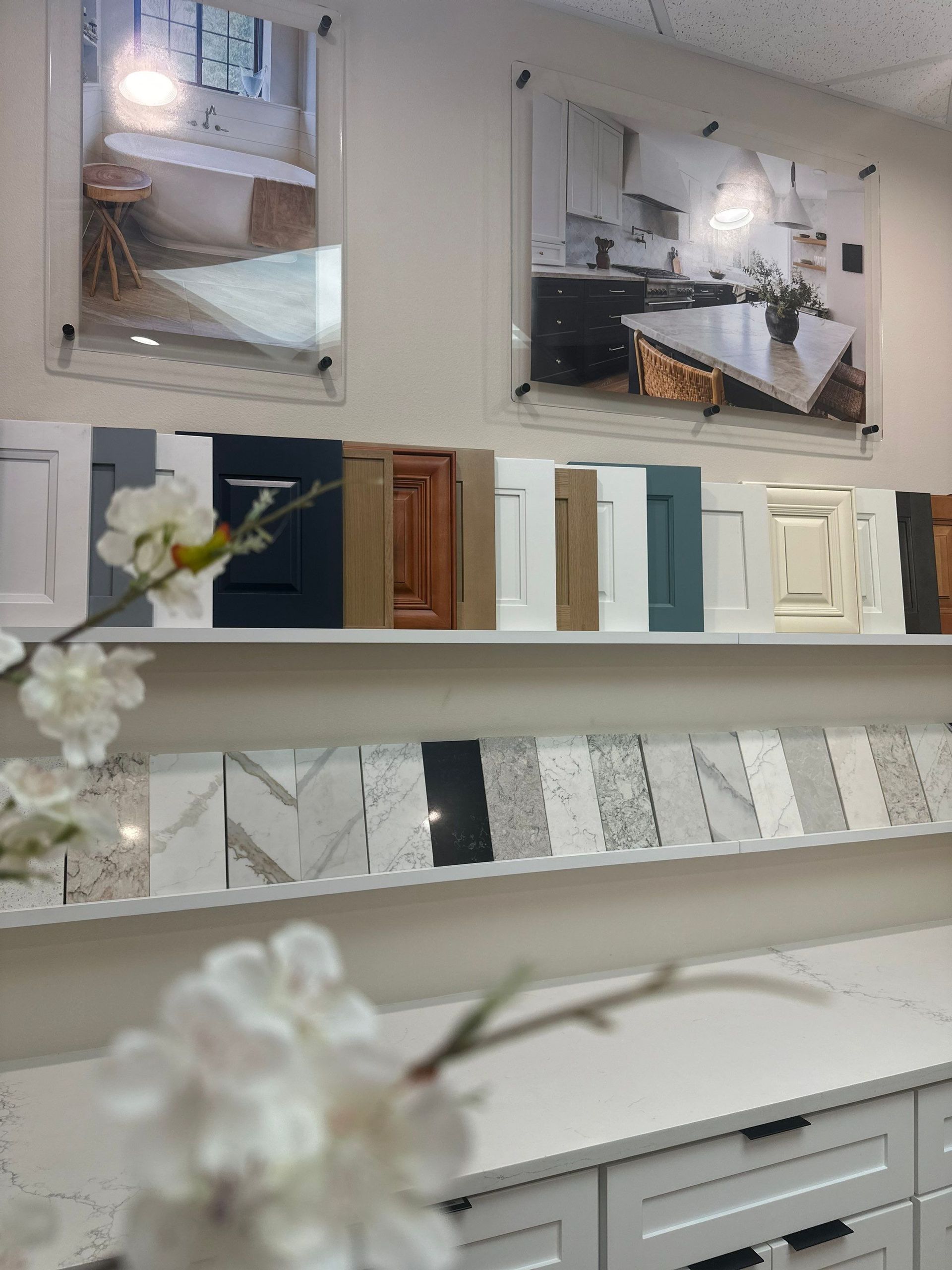 Wallpaper samples and mirrored decor displayed on shelves in a bright showroom