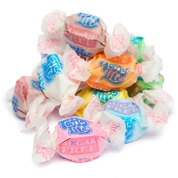 Assorted colorful wrapped candies piled together on a white background